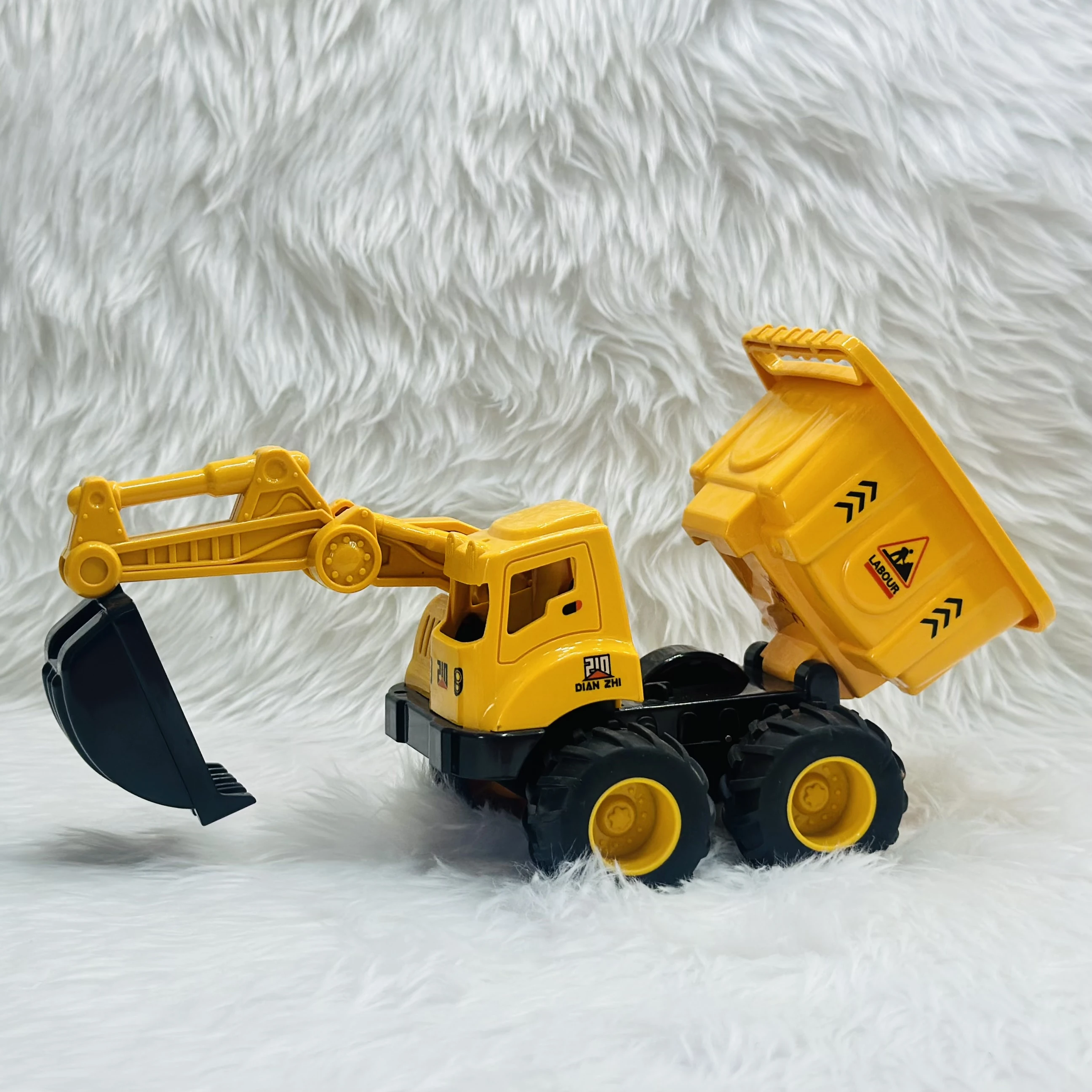 Yellow plastic toy construction vehicle, specifically a 2-in-1 friction-powered dumper and excavator truck.