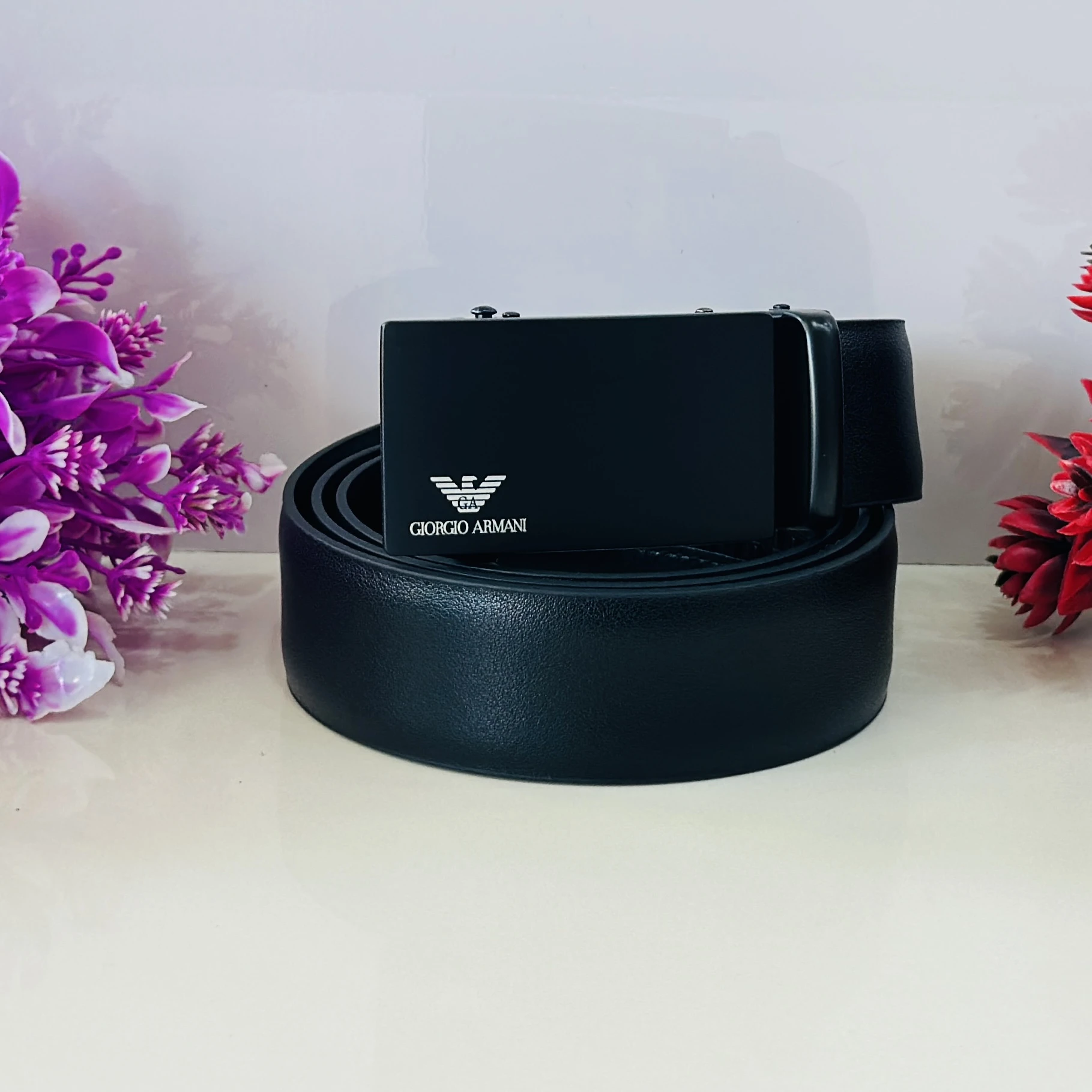 Emporio Armani black leather belt with a logo plaque buckle.