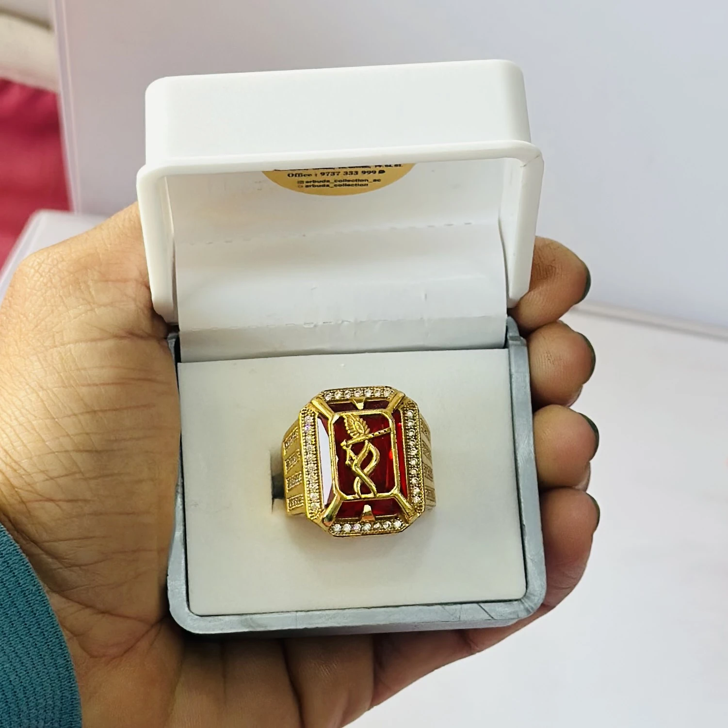 1 gram gold-plated Mudra ring with a red stone centerpiece.