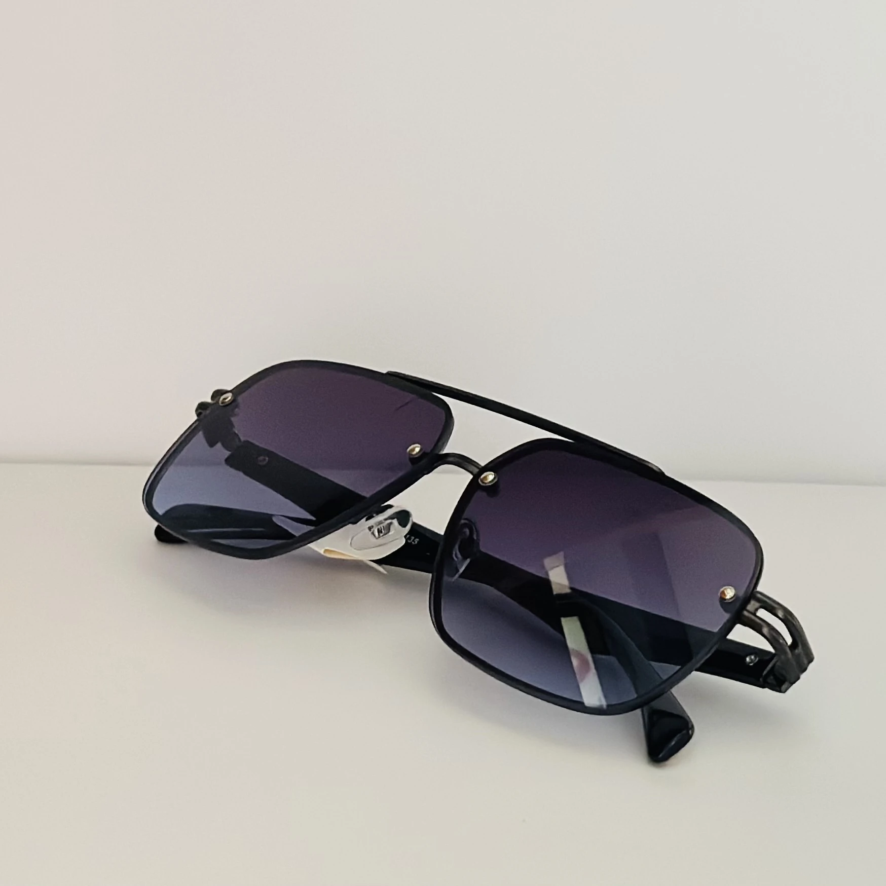 black rimless aviator sunglasses with blue gradient lenses.