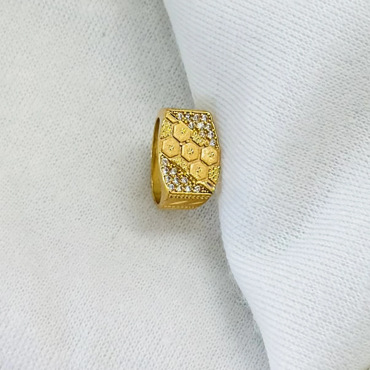 Gold men's ring with a hexagonal design and small white stones.