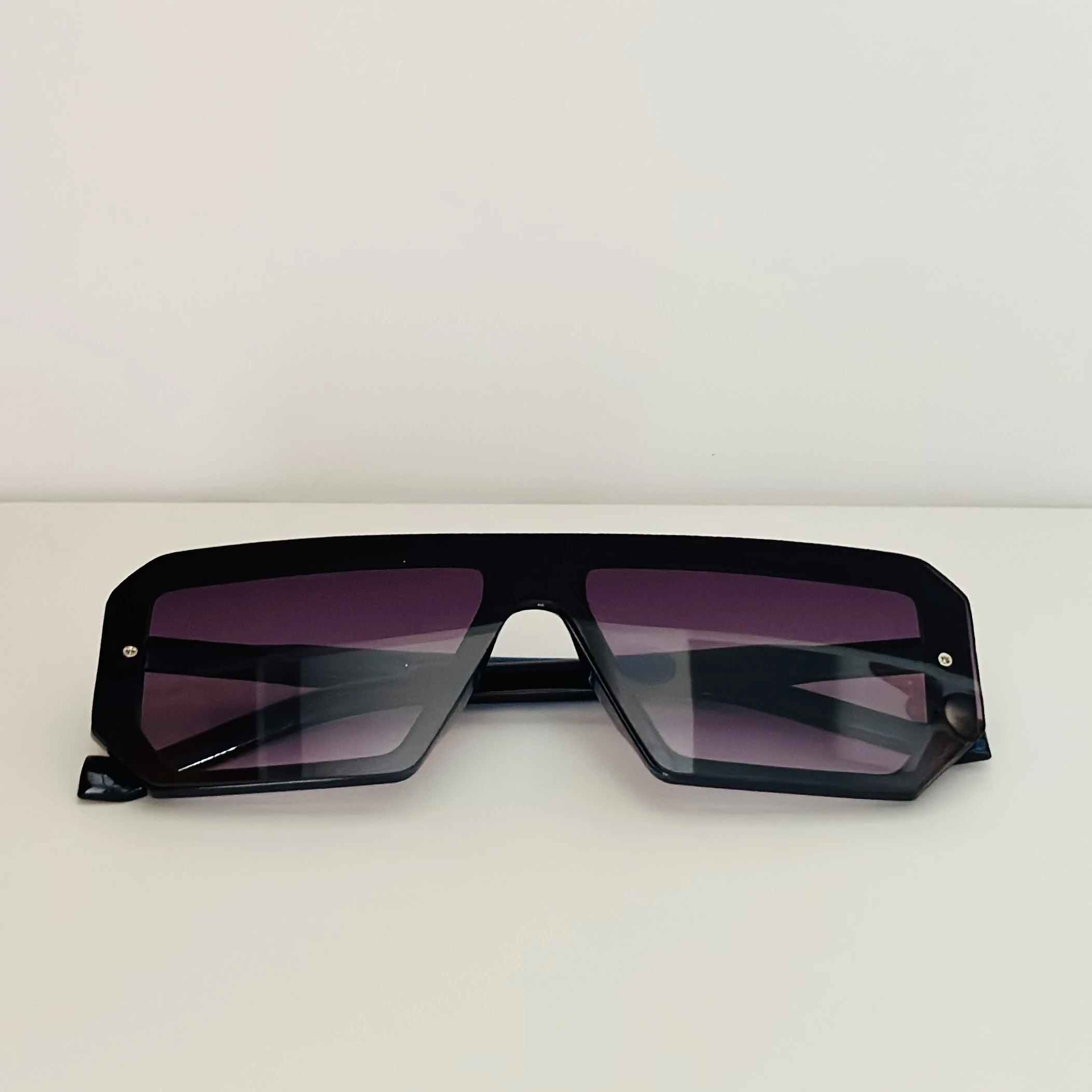 black polycarbonate oversized rectangular sunglasses.