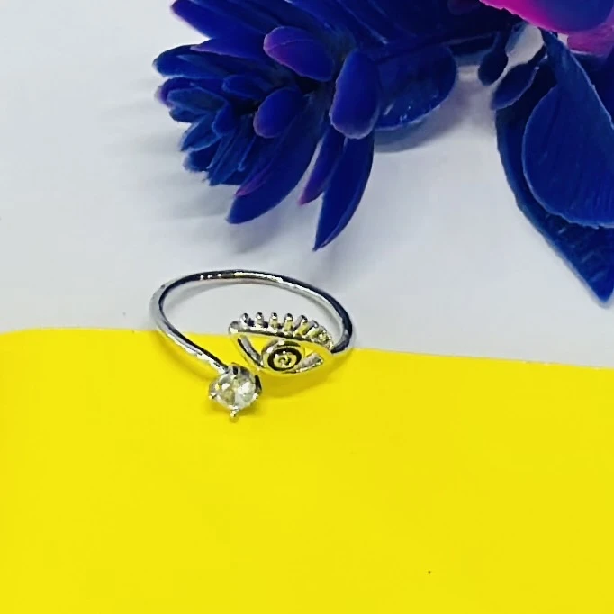 an adjustable sterling silver "evil eye" ring with a clear cubic zirconia stone.