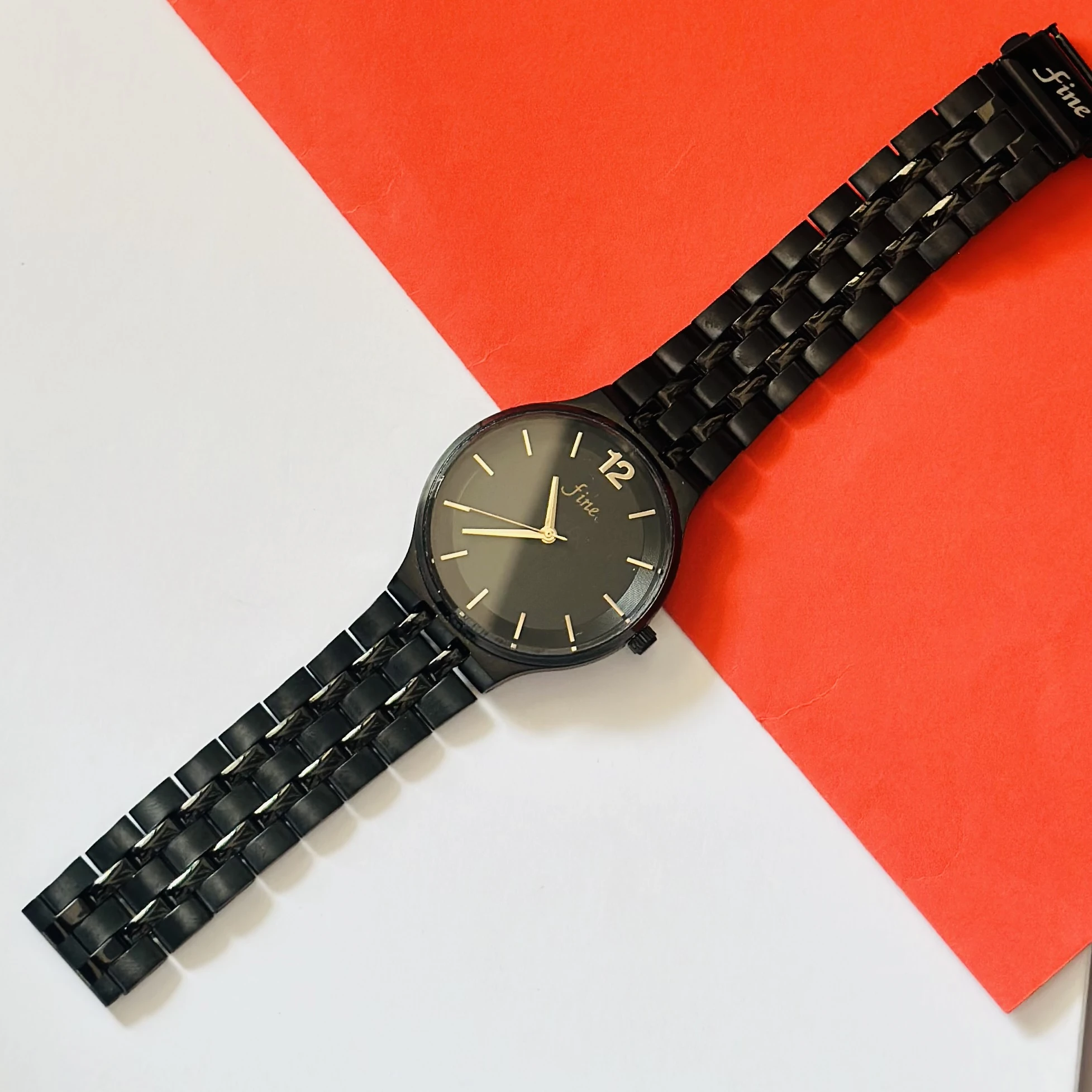 Analog watch with a black stainless steel bracelet and black dial.
