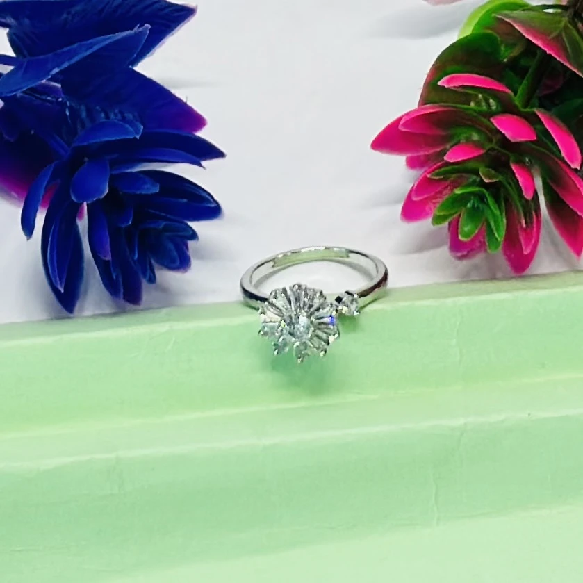 Silver toe ring featuring a white zircon floral design.