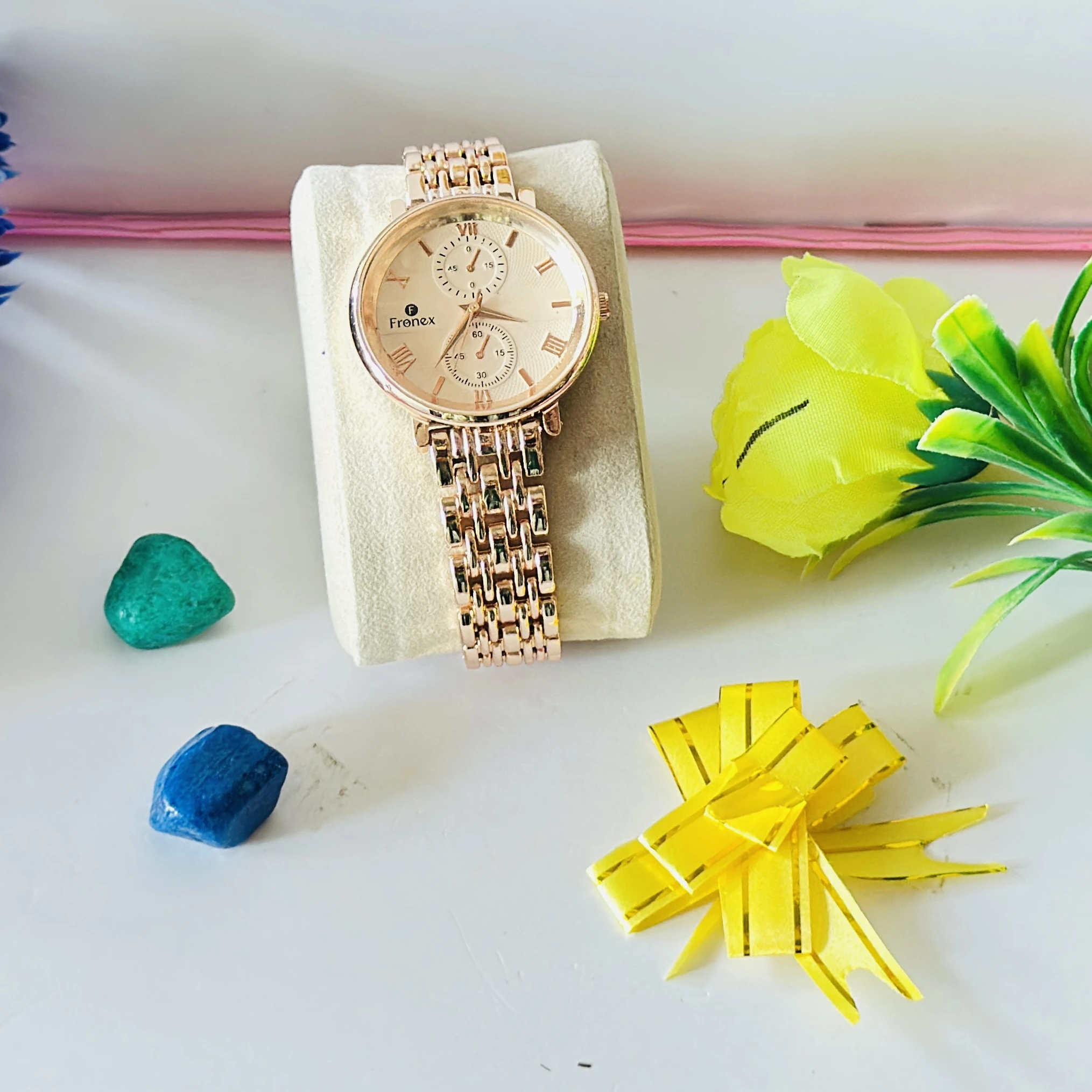 Frenex brand rose gold analog wristwatch with a metal strap