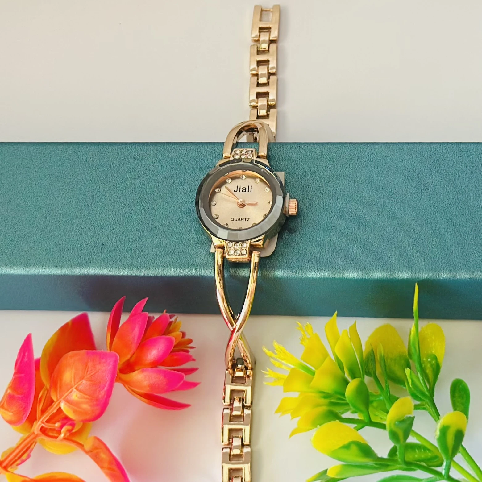 Rose gold-toned women's bracelet watch with a crystal-accented dial.