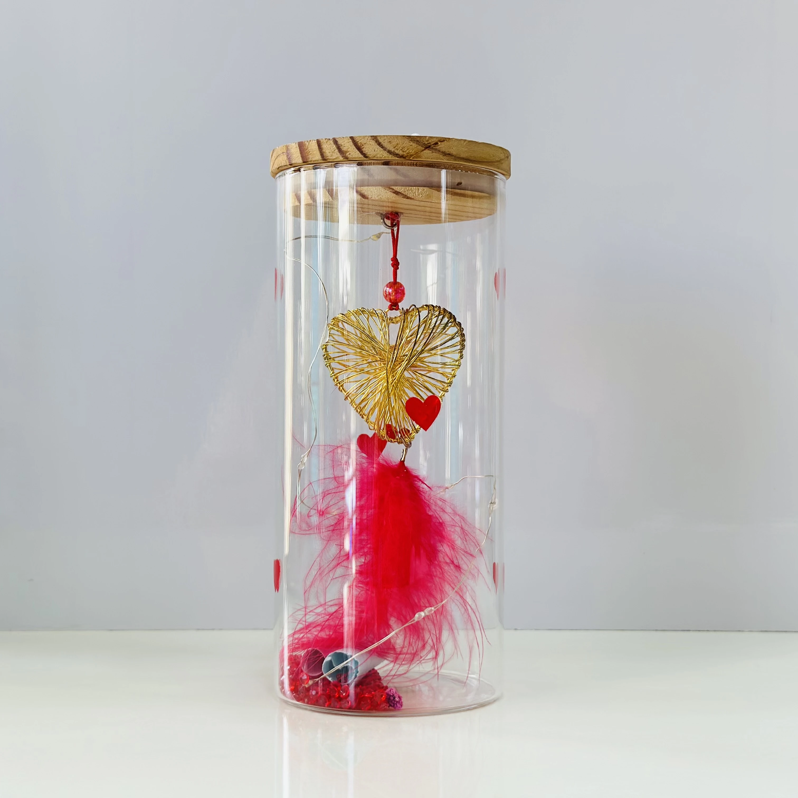 glass light with a wire heart, red feathers, and LED fairy lights. (SKU-86EZEW)