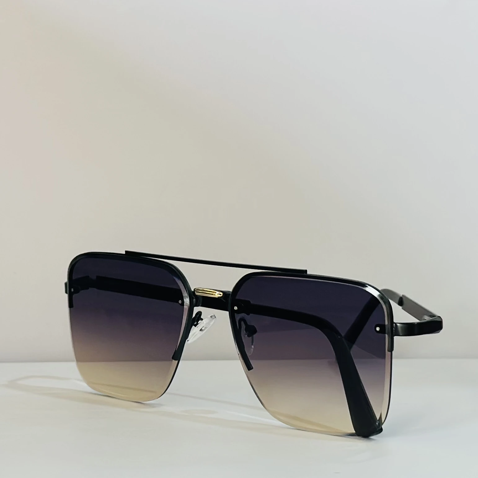 pair of Sam & Marshall Dario sunglasses with black frames and gradient lenses.