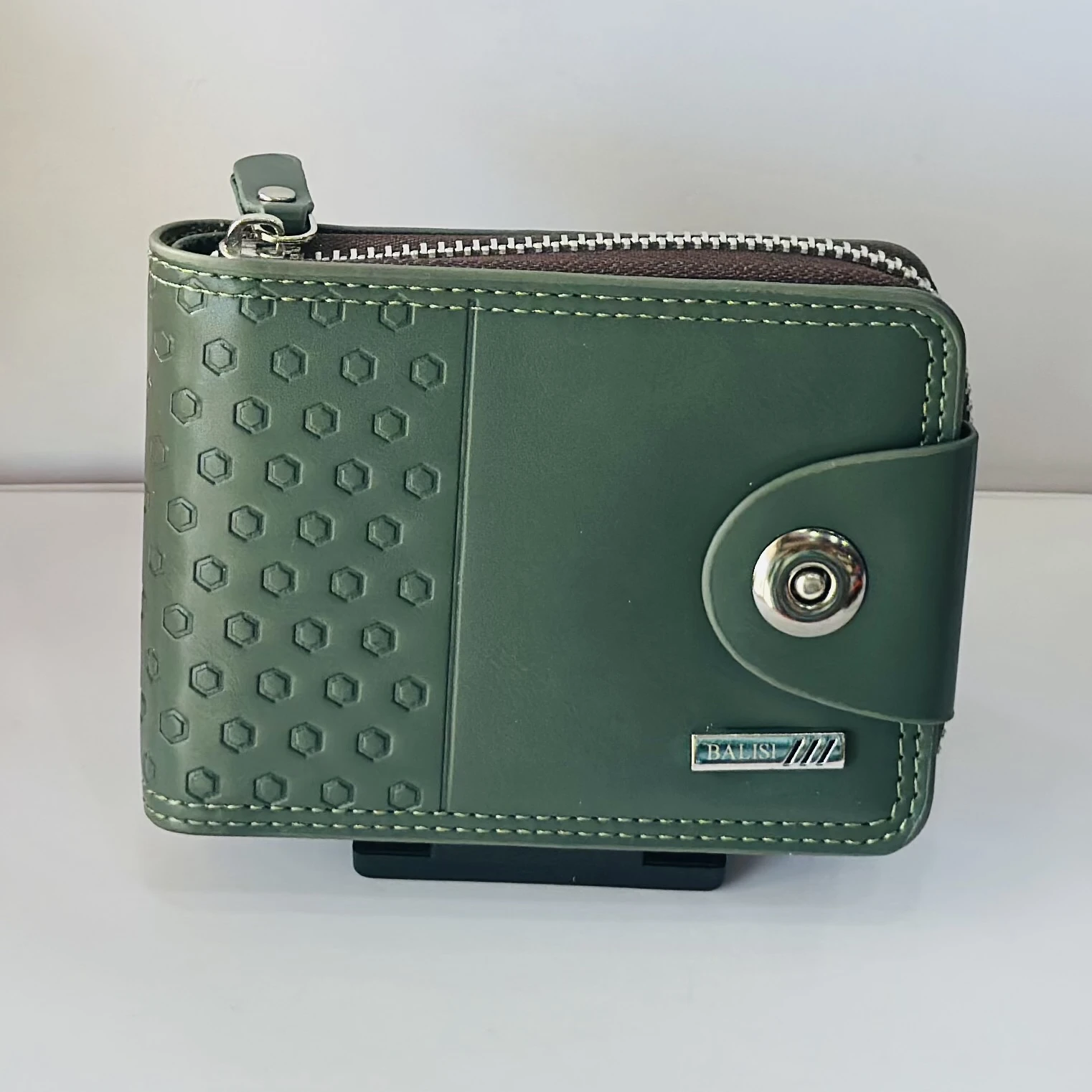 Balisi green leather wallet with a button closure.