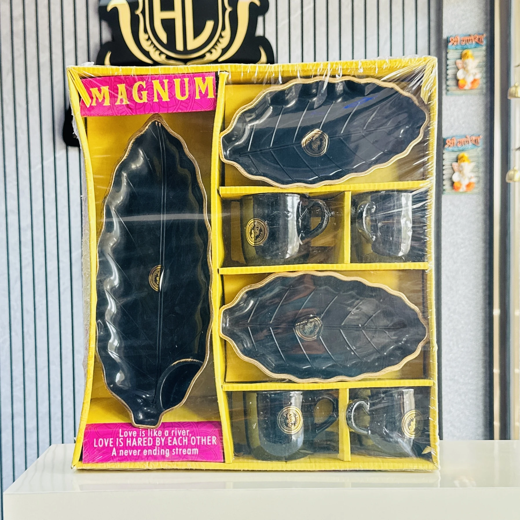 an 8-piece ceramic cup and leaf-shaped serving platter set in black. ….0OA4GH