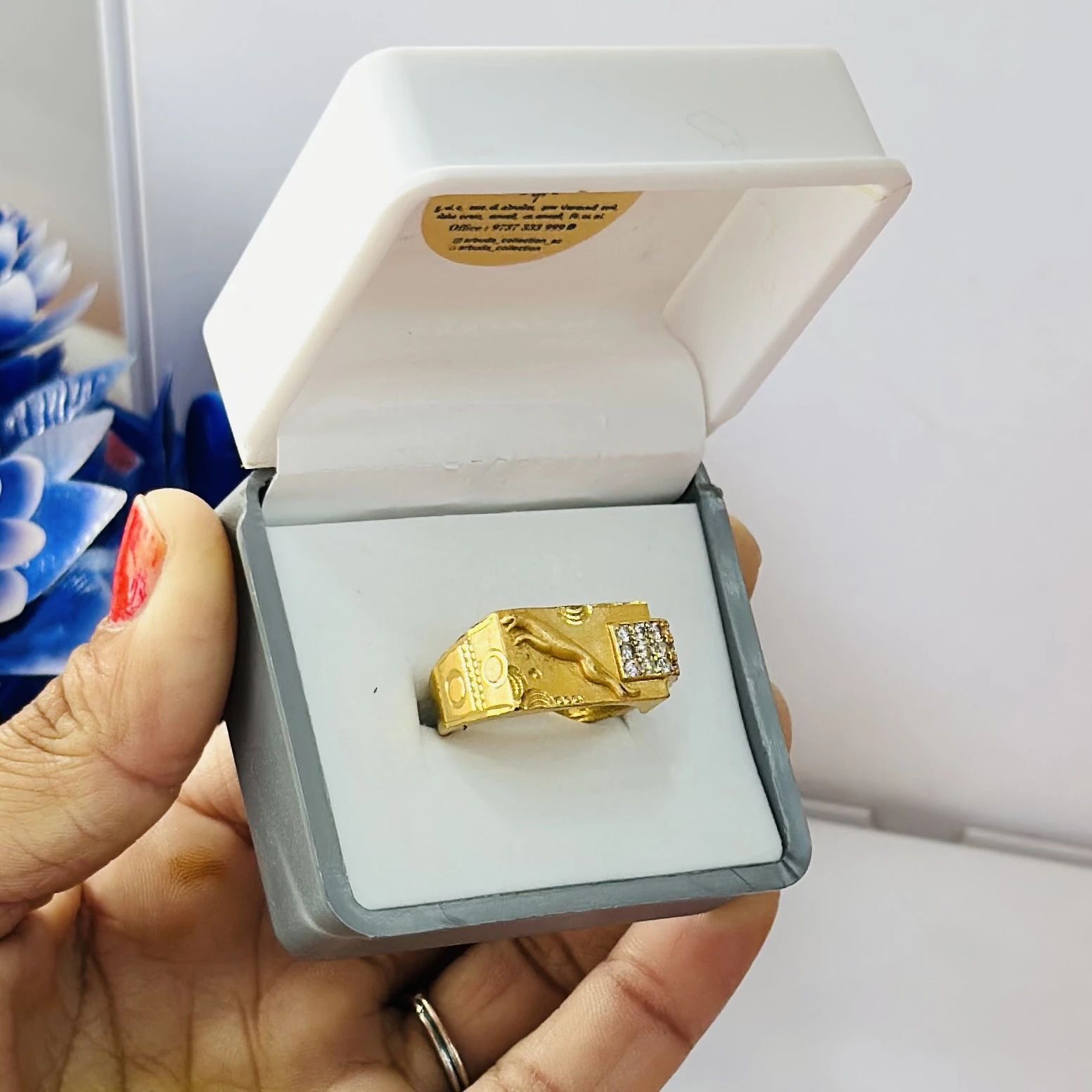 gold gent's ring with a textured design and diamond accents.