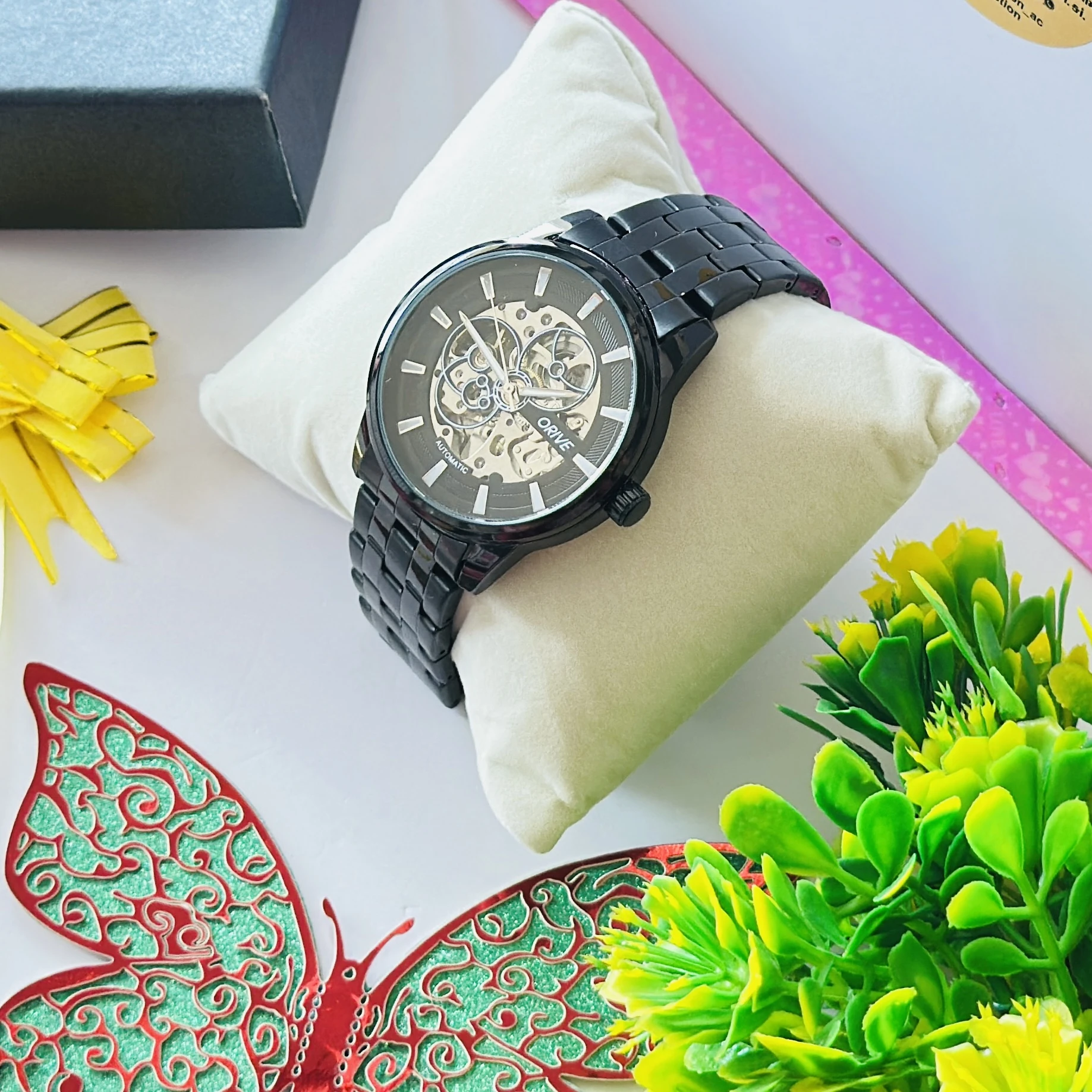 Black Fossil automatic watch with a skeleton dial, featuring a metallic strap.