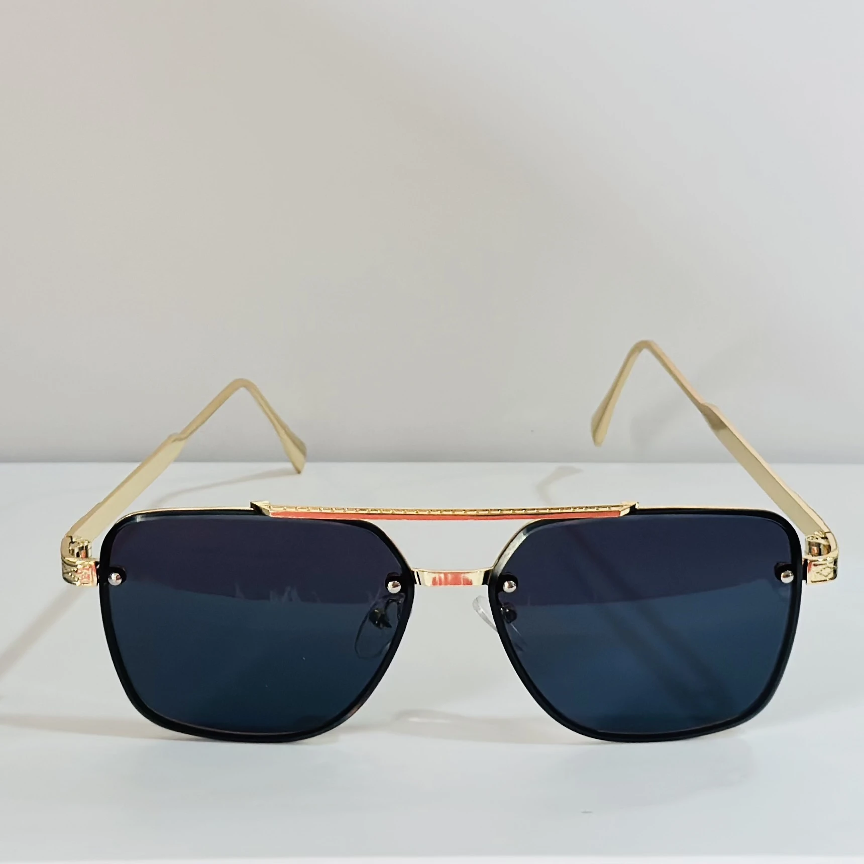 pair of Versace VE 2275 sunglasses with a gold metal frame and black/grey lenses.
