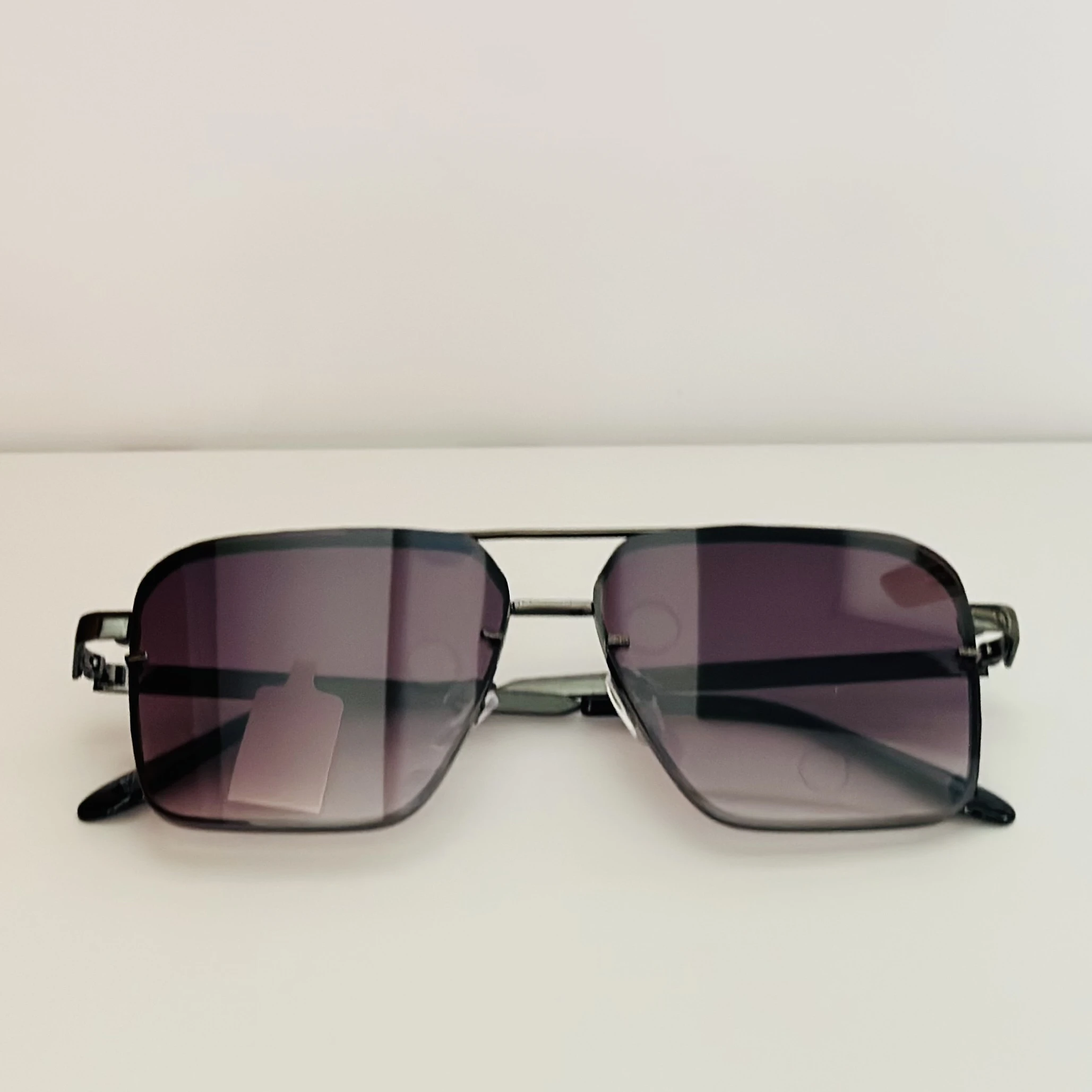 pair of square aviator gradient sunglasses with a black metal frame.