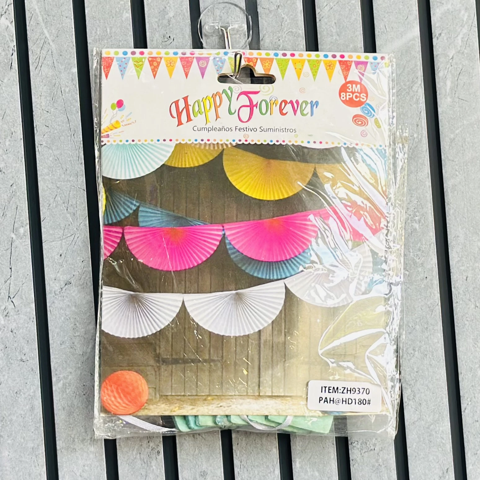 package of "Happy Forever" brand paper fan garland party decorations.
