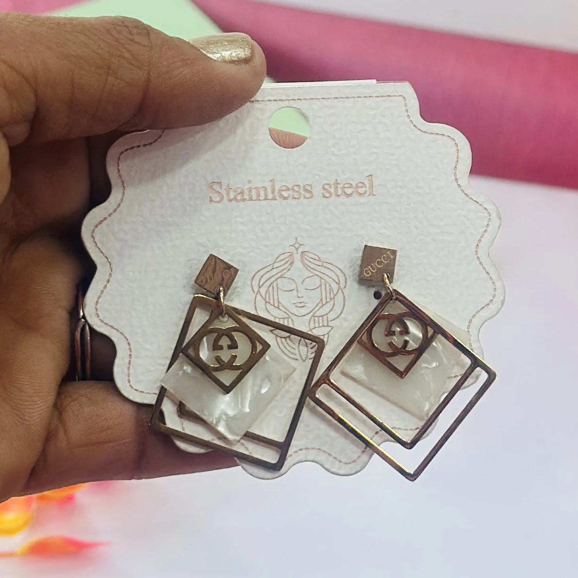 pair of anti-tarnish rose gold plated concentric chain drop earrings.
