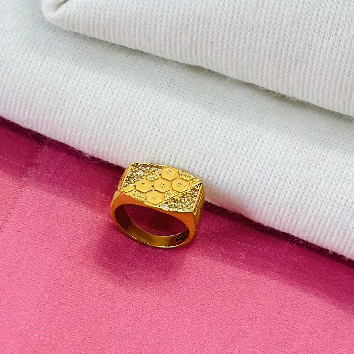 Gold men's ring with a hexagonal design and small white stones.