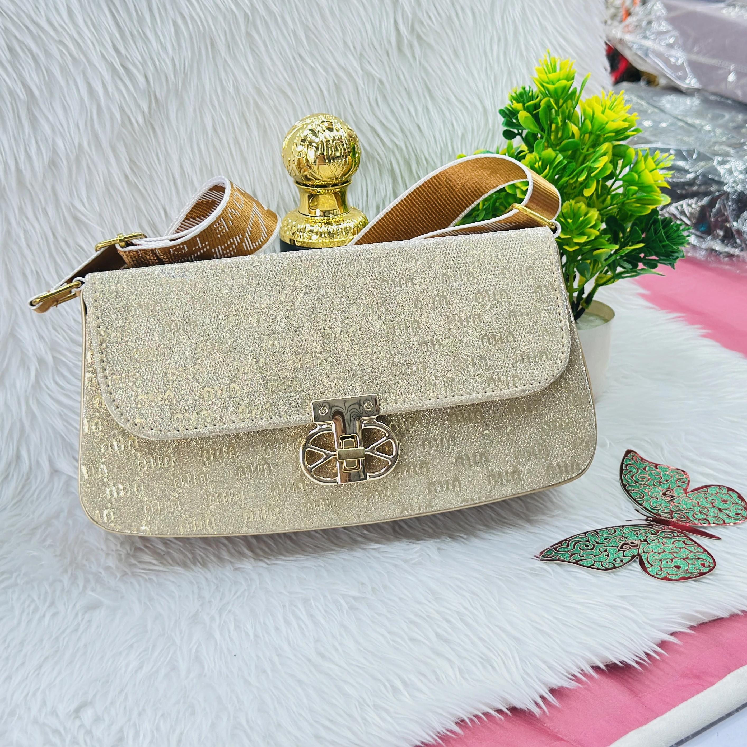 Gold colored, glittery structured handbag
