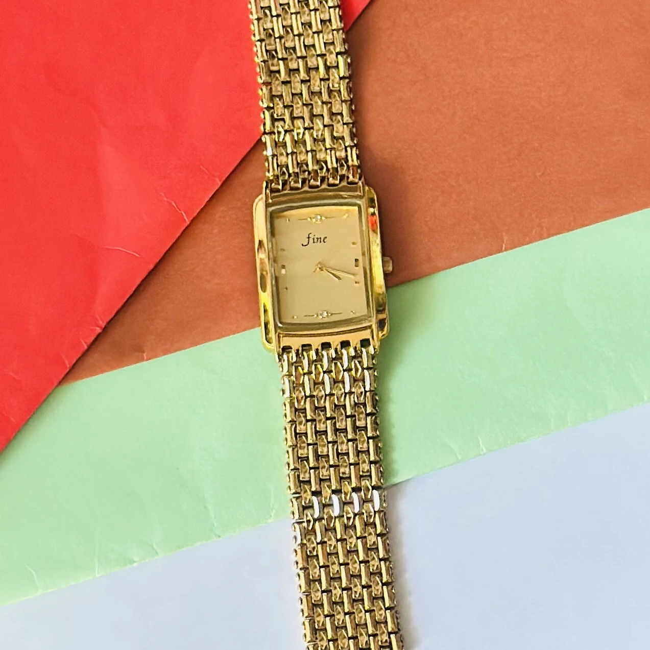 Gold -tone analog quartz watch with a metal strap.