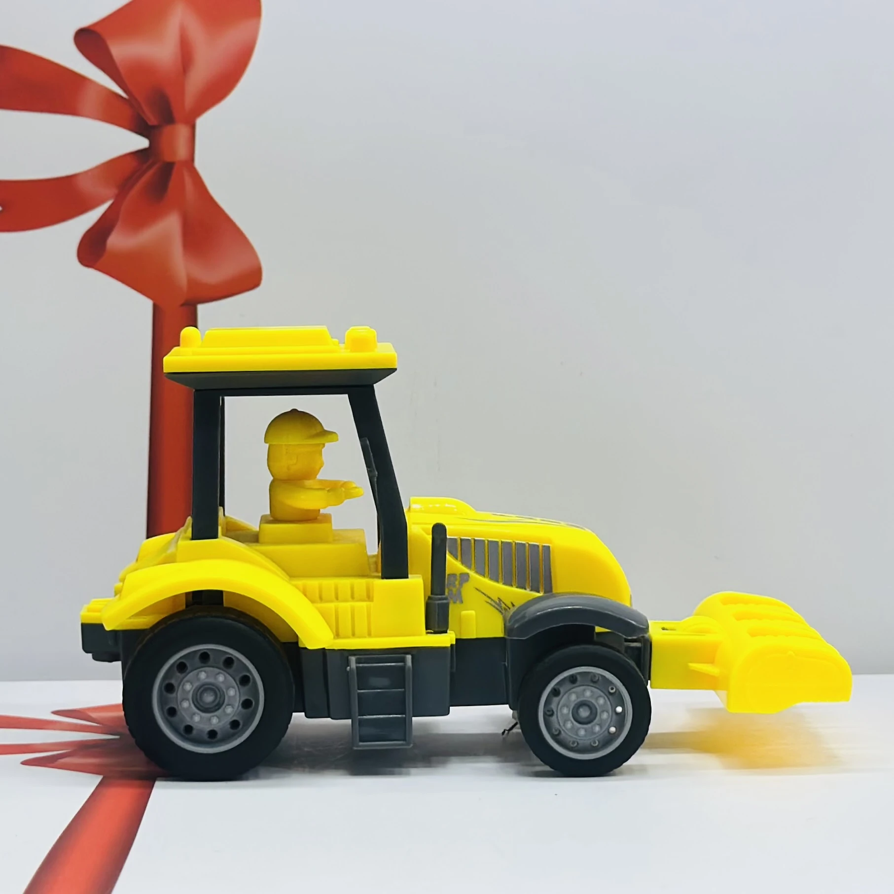 Yellow plastic toy tractor