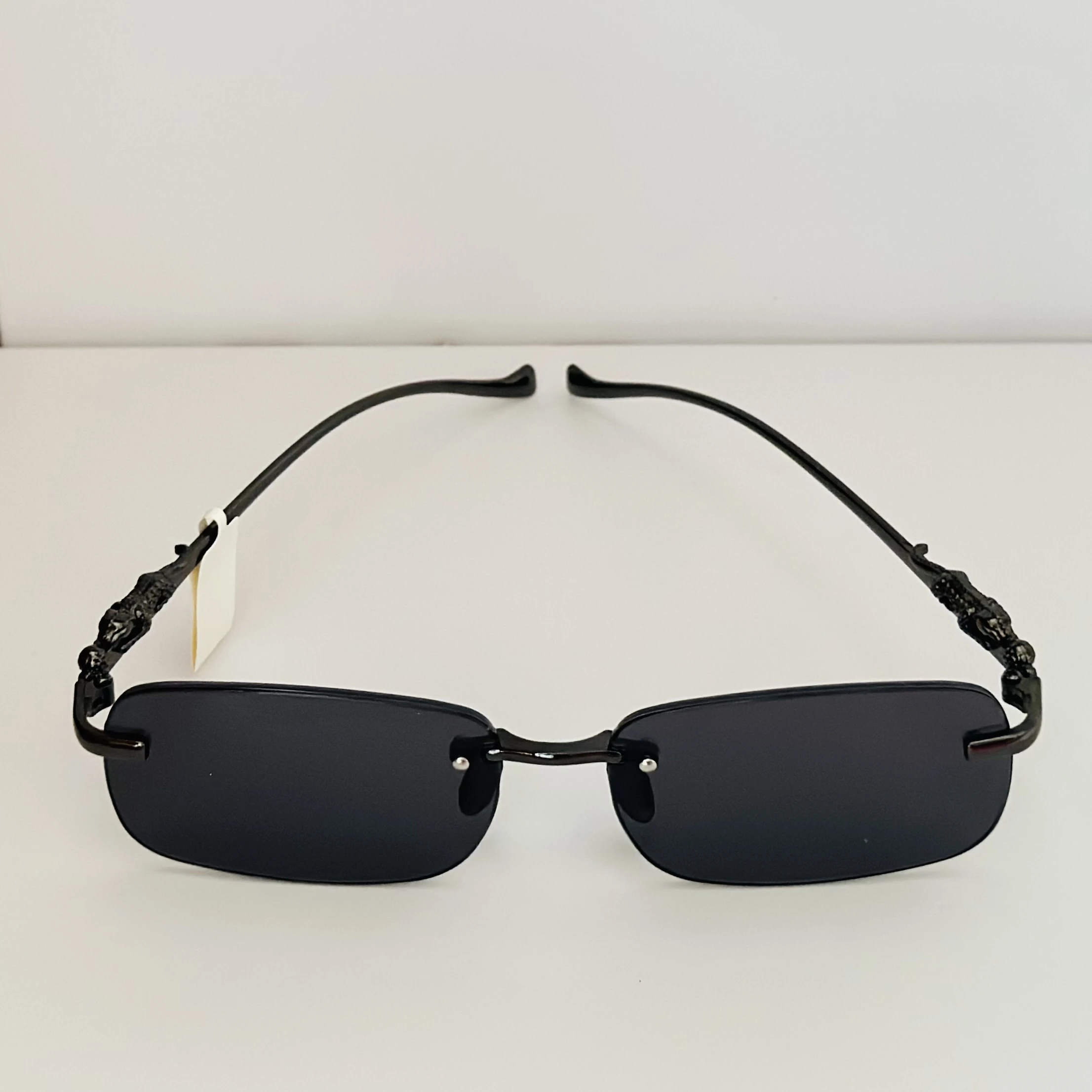 Creature Mc Stan rimless unisex rectangular sunglasses in black.