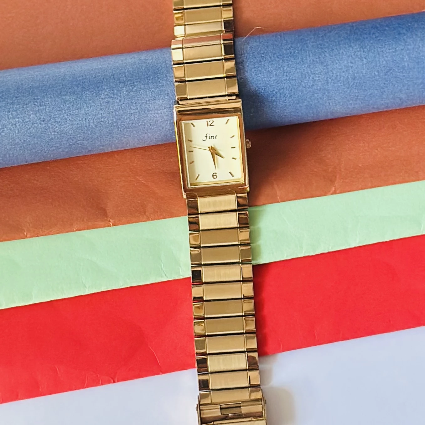 Gold -tone analog quartz watch with a metal strap.