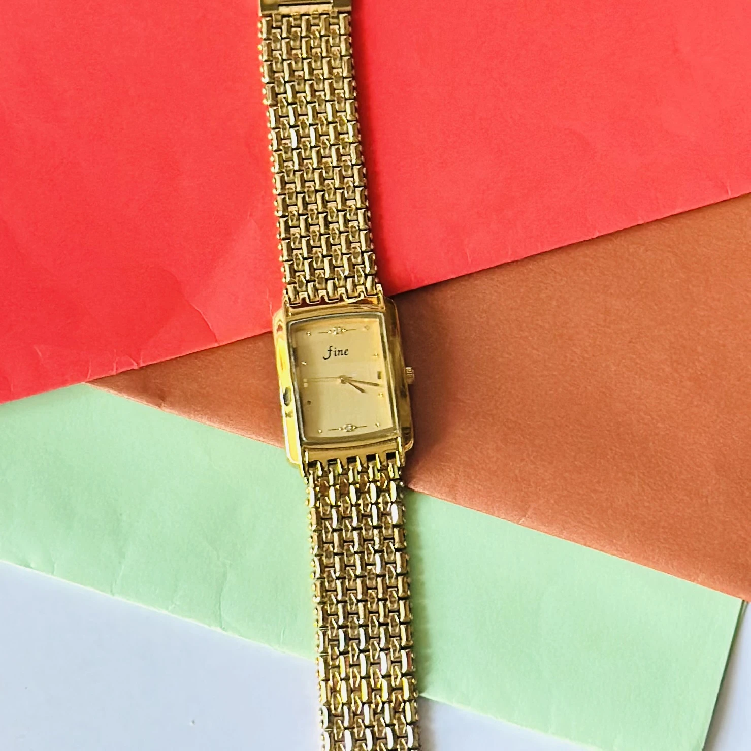 Gold -tone analog quartz watch with a metal strap.