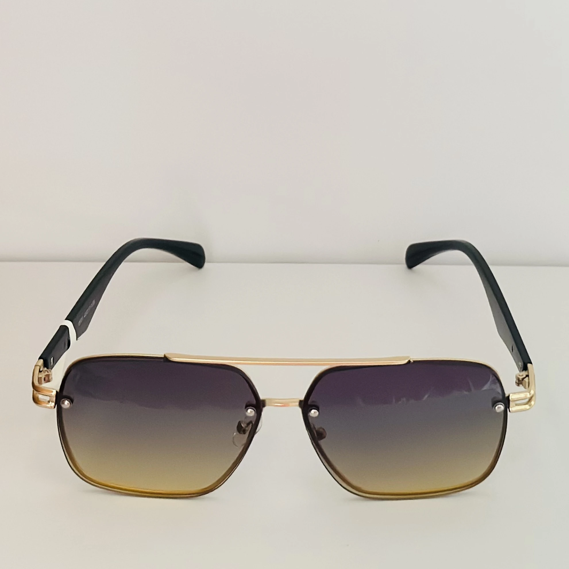 square aviator sunglasses with a gold-toned metal frame and brown gradient lenses