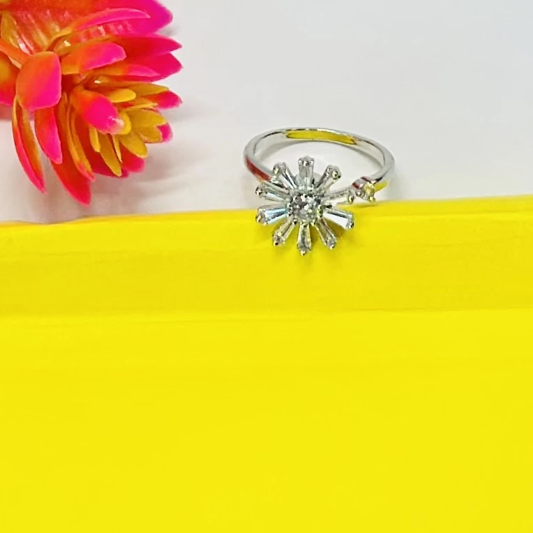 silver-plated cubic zirconia studded floral or starburst finger ring.