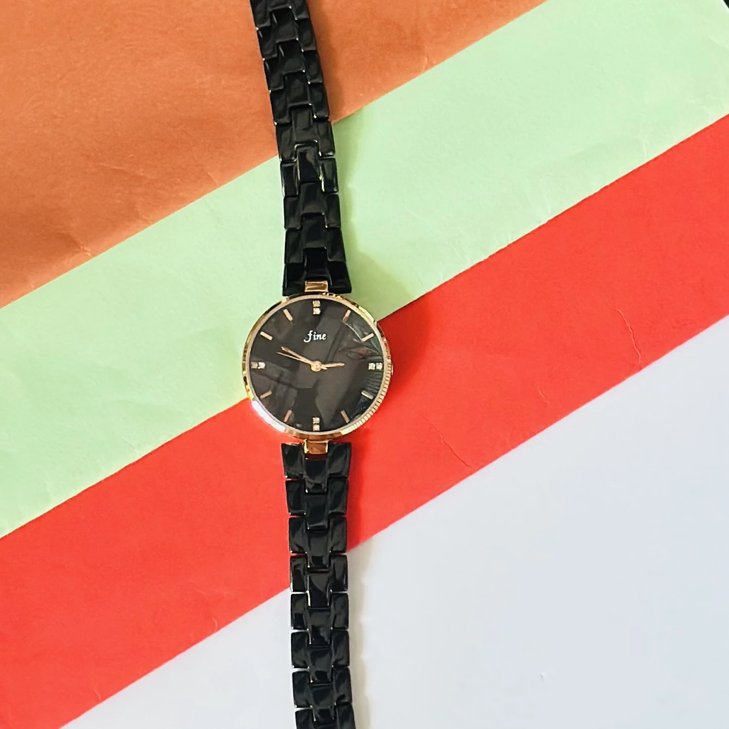 LeForce analog women's watch with a black dial, gold-plated case, and black bracelet strap