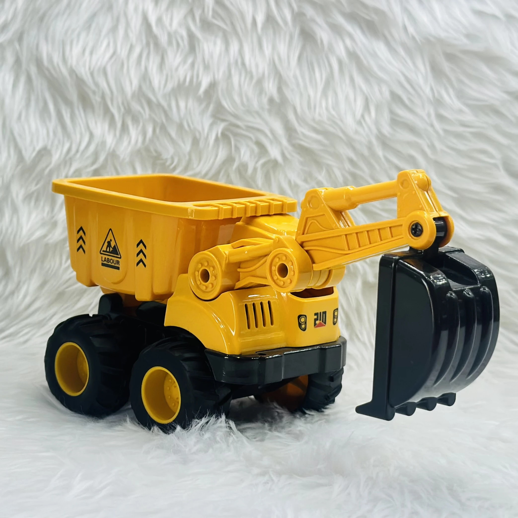 Yellow plastic toy construction vehicle, specifically a 2-in-1 friction-powered dumper and excavator truck.