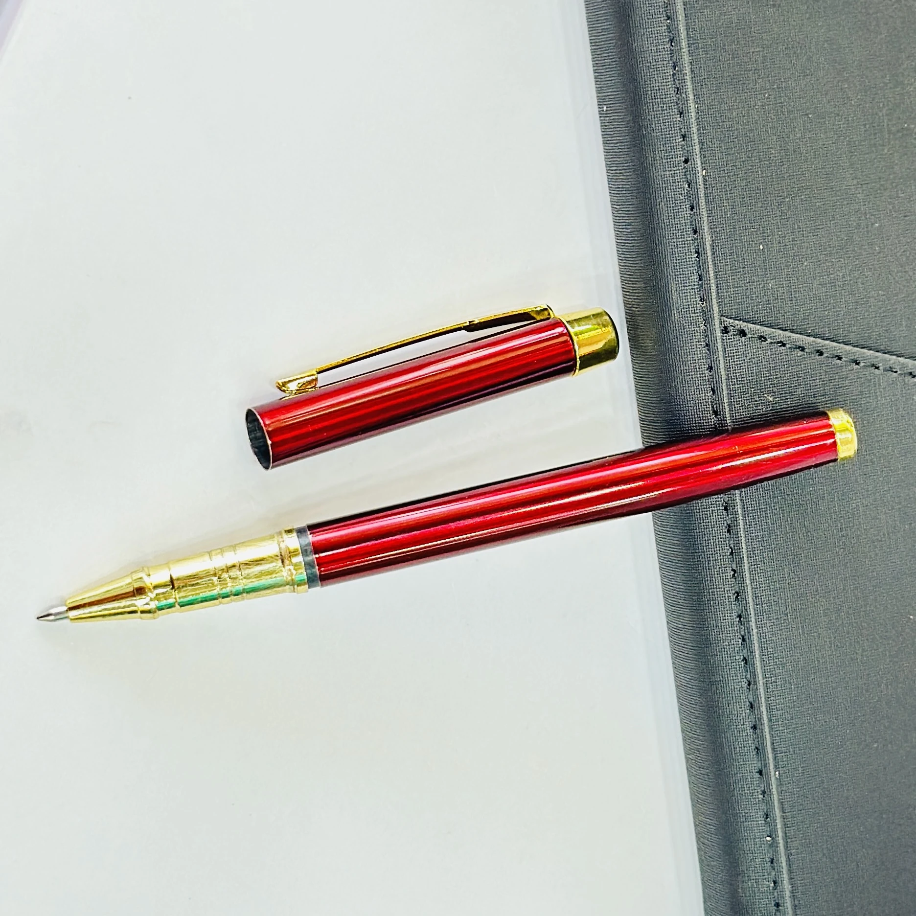 sleek maroon and gold metal rollerball pen