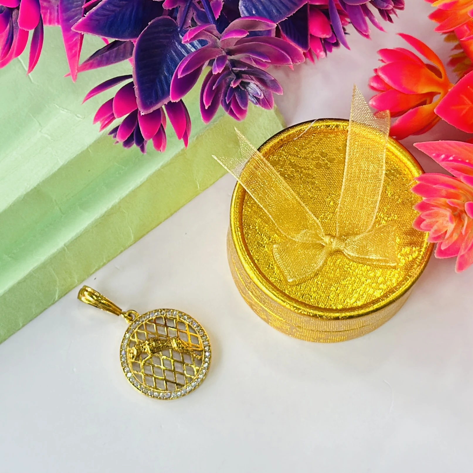 Gold plated jaguar pendant with a diamond texture background.