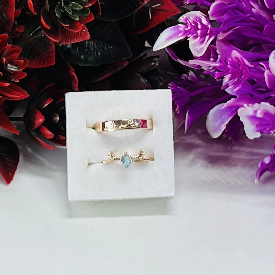 Rose gold nature-inspired wedding bands featuring a plain band and a twig branch ring