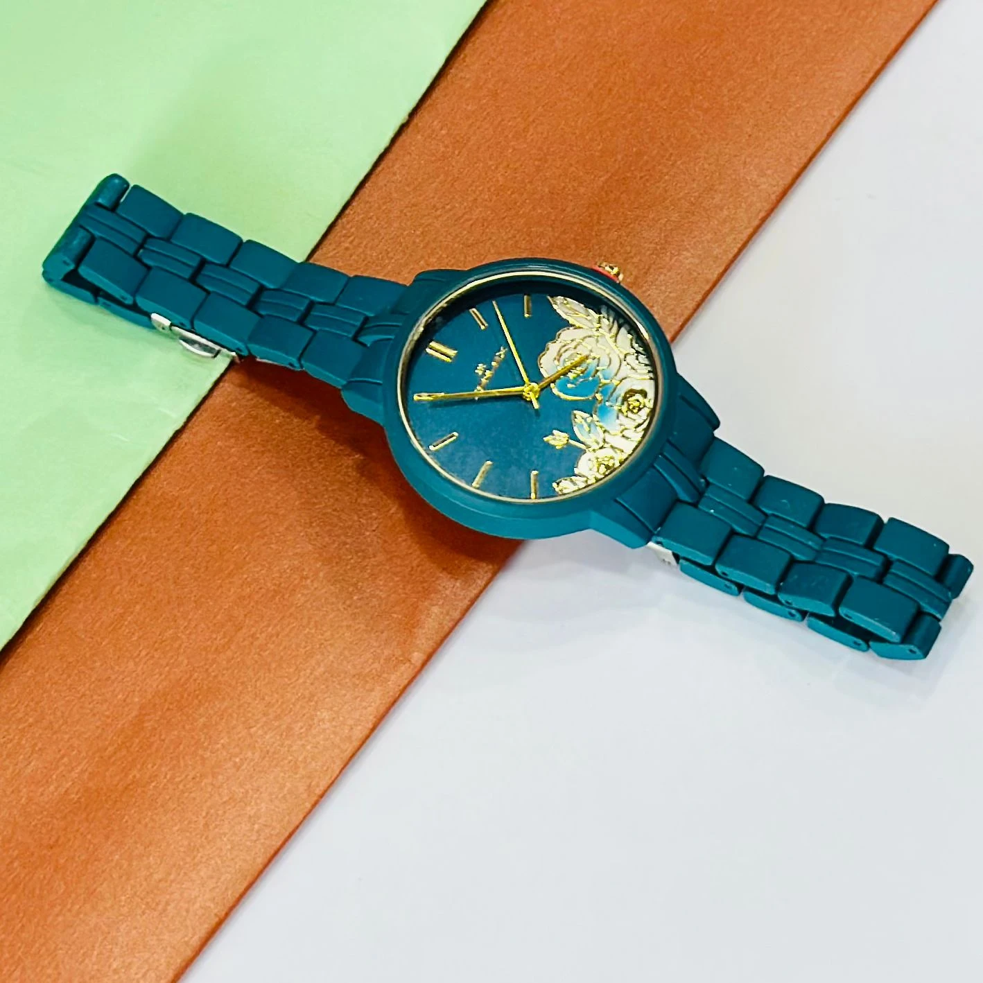 TEAL BY CHUMBAK Tulip Garden Quilted Analog Watch for Women in a teal blue hue.