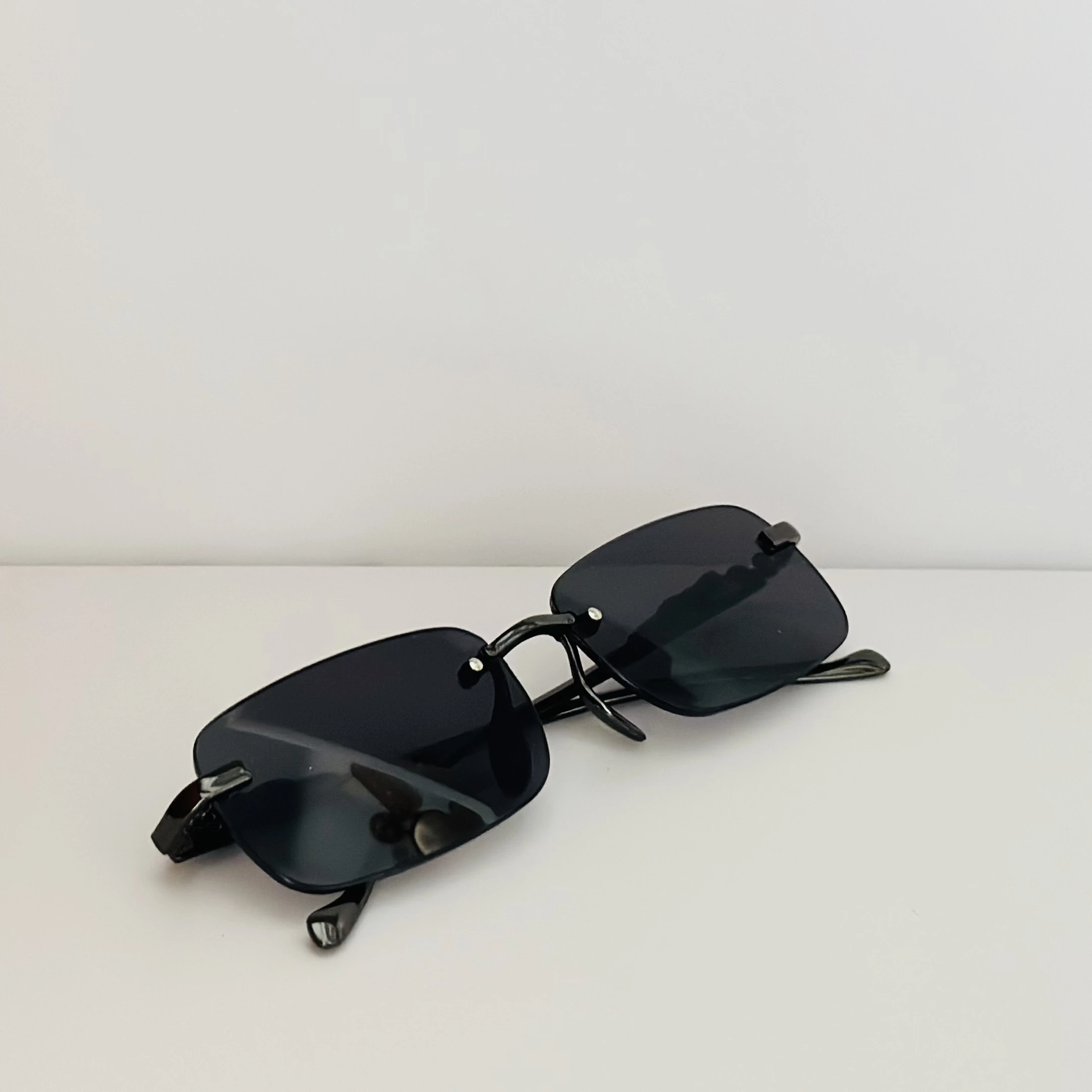 Creature Mc Stan rimless unisex rectangular sunglasses in black.