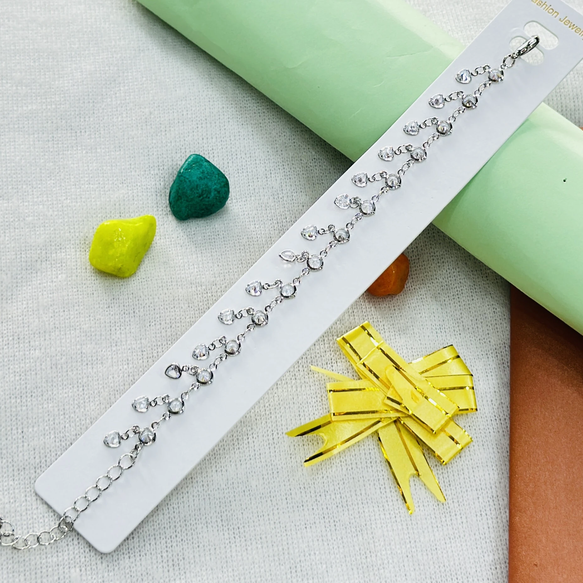 silver-plated anklet features dangling rhinestone