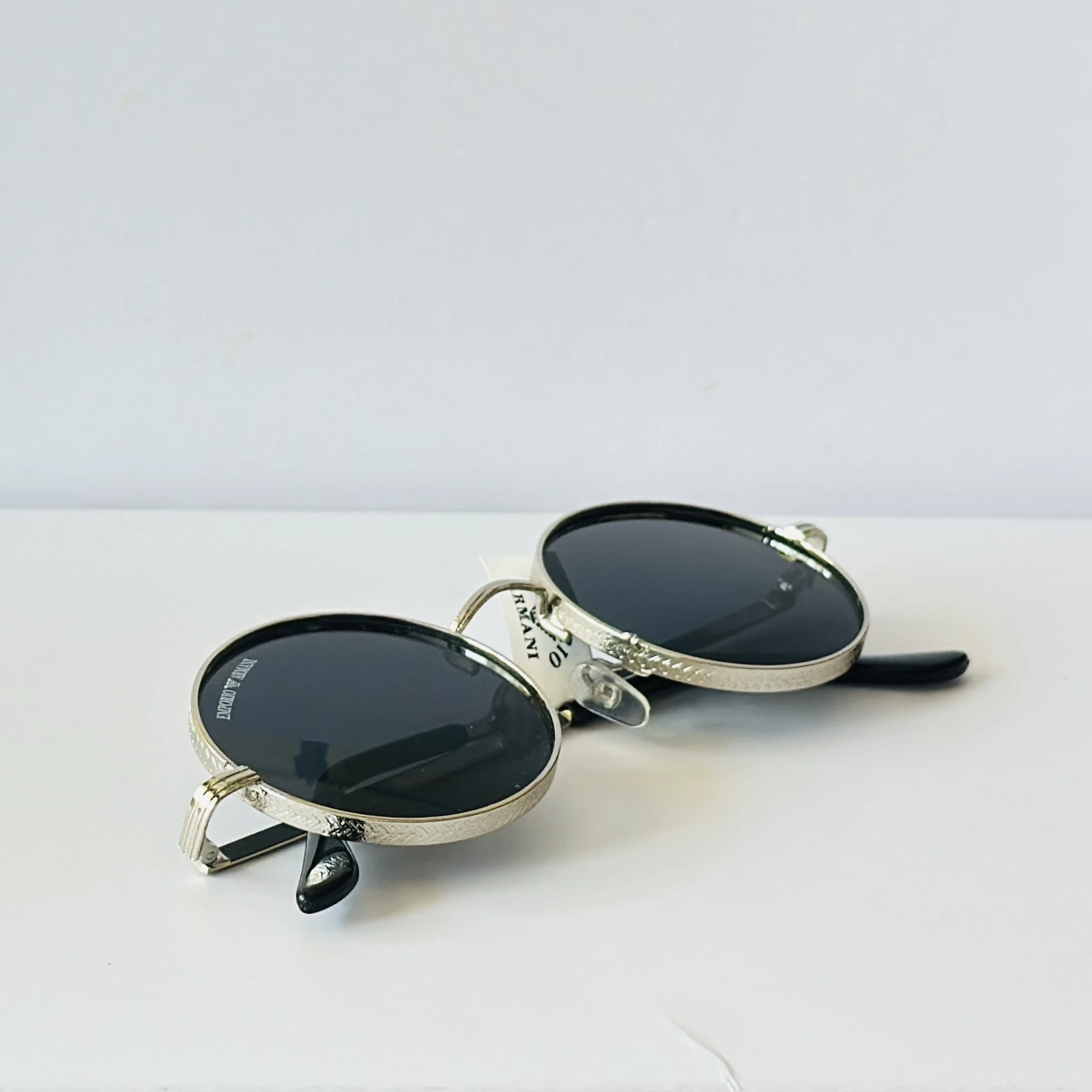 Emporio Armani sunglasses feature a distinctive round metal frame design.