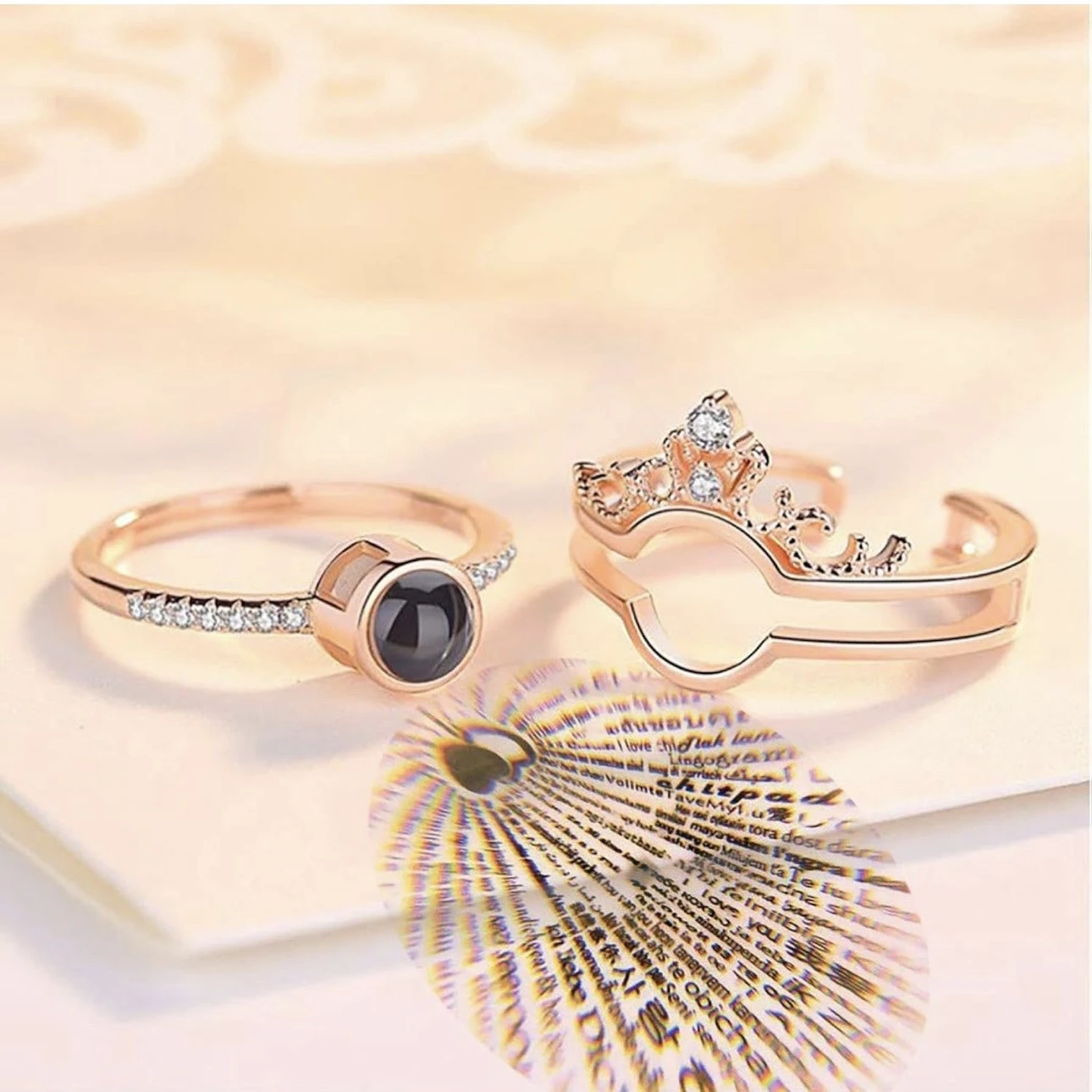 crown-design "I Love You" in 100 languages projection ring, often made from a zinc alloy or artificial material.