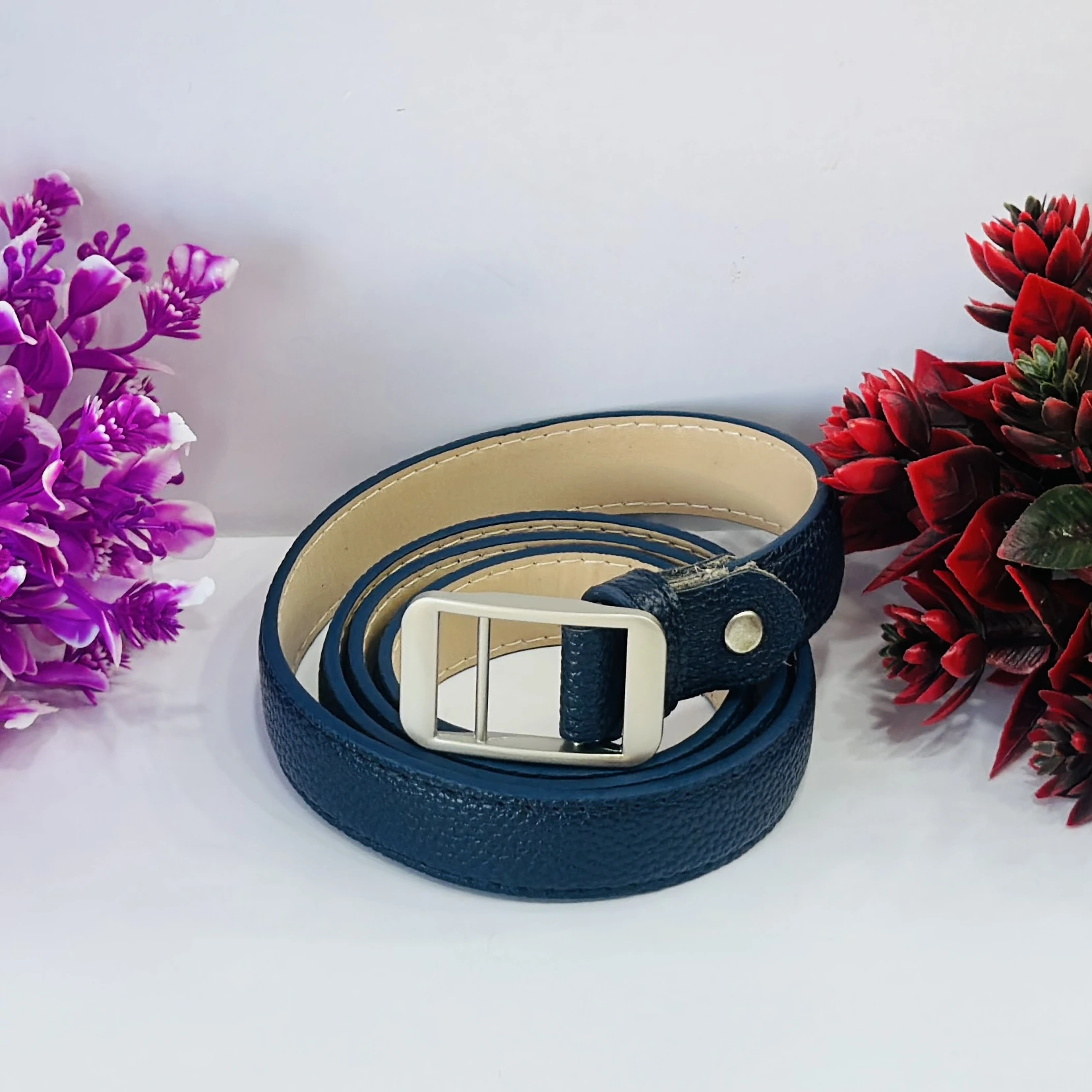 Blue leather belt with a silver-tone buckle.