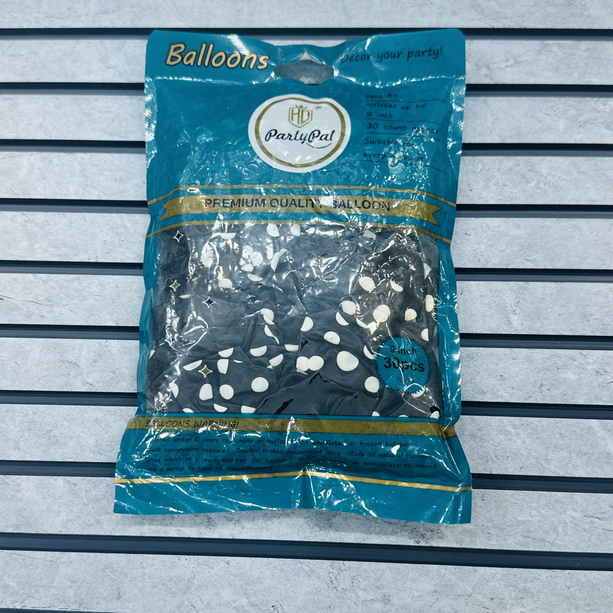 package of black party balloons with white polka dots.