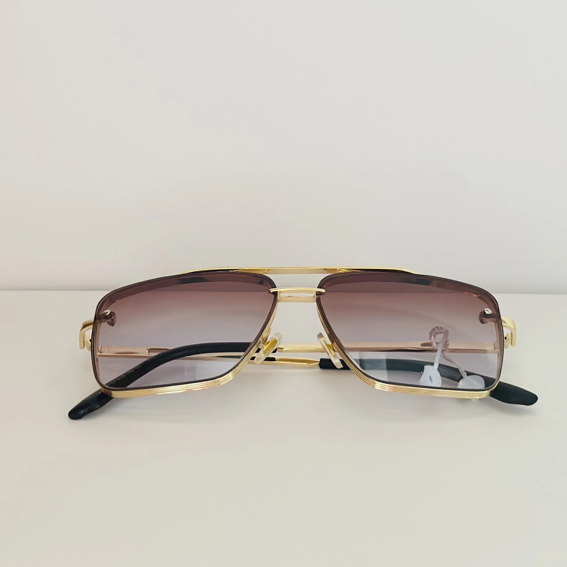 pair of DITA Mach-Six sunglasses with gold-tone frames and brown-to-clear gradient lenses