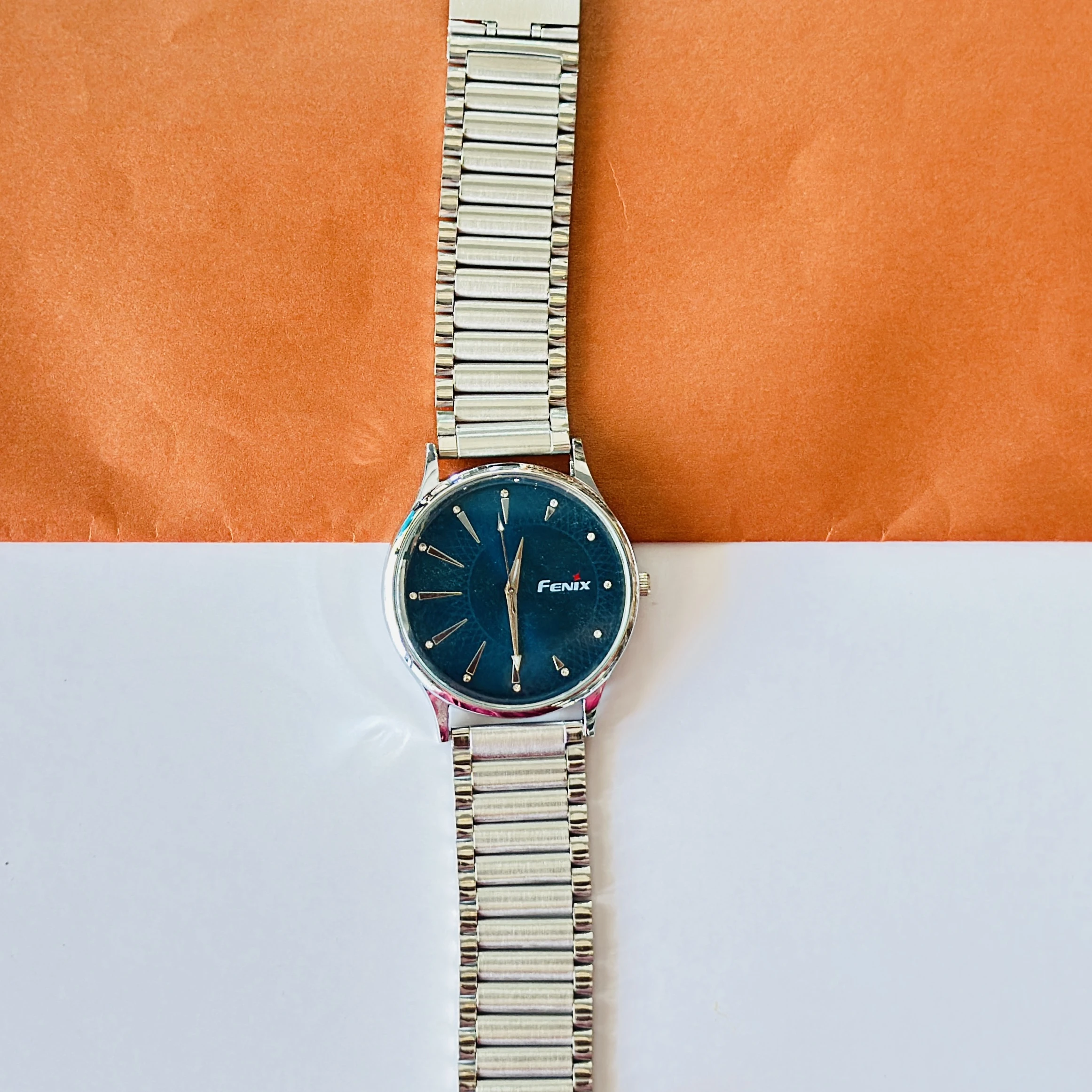 Blue dial with stick indices and a silver-toned stainless steel strap