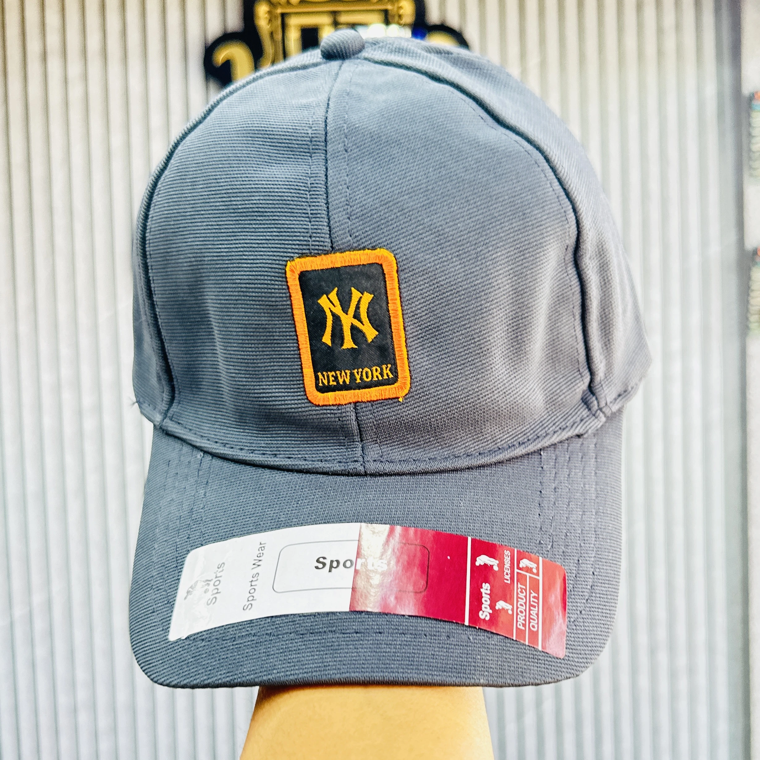 Gray baseball cap features the New York Yankees logo.