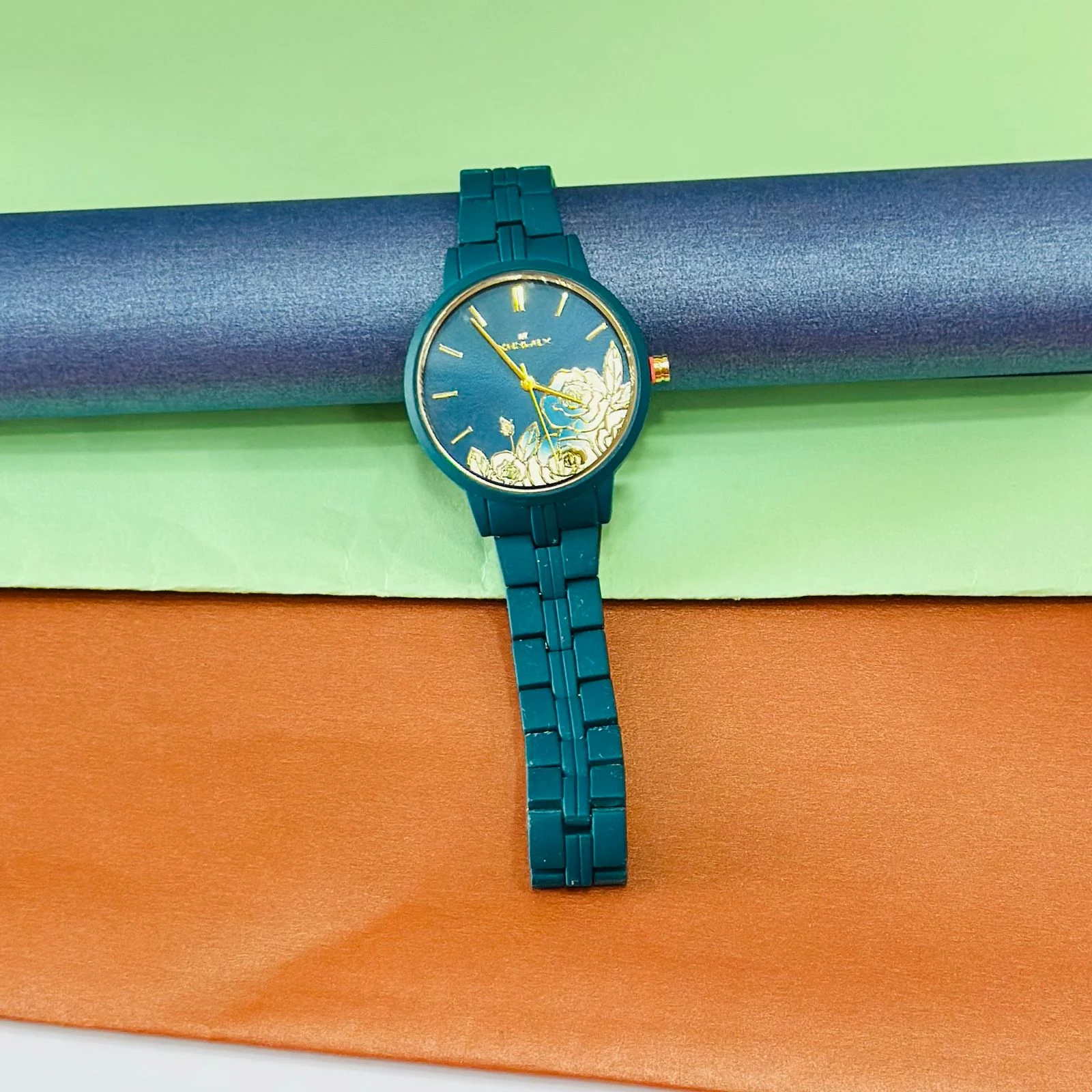 TEAL BY CHUMBAK Tulip Garden Quilted Analog Watch for Women in a teal blue hue.