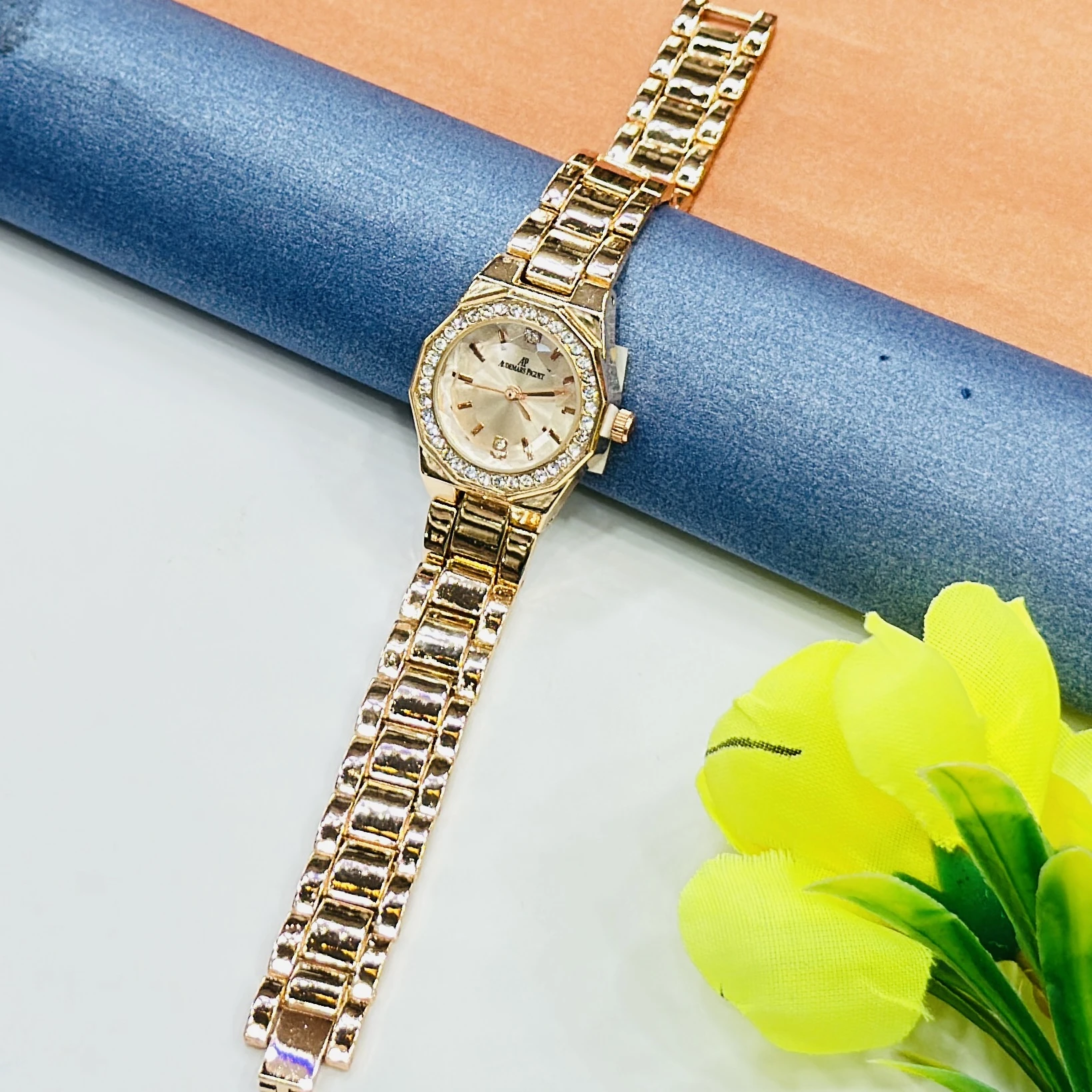 gold-tone ladies' watches with a sparkling bezel and metallic strap