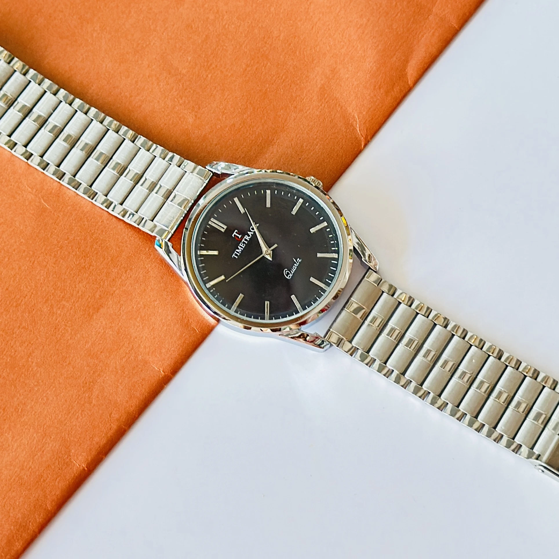 Silver coloured analogue watch