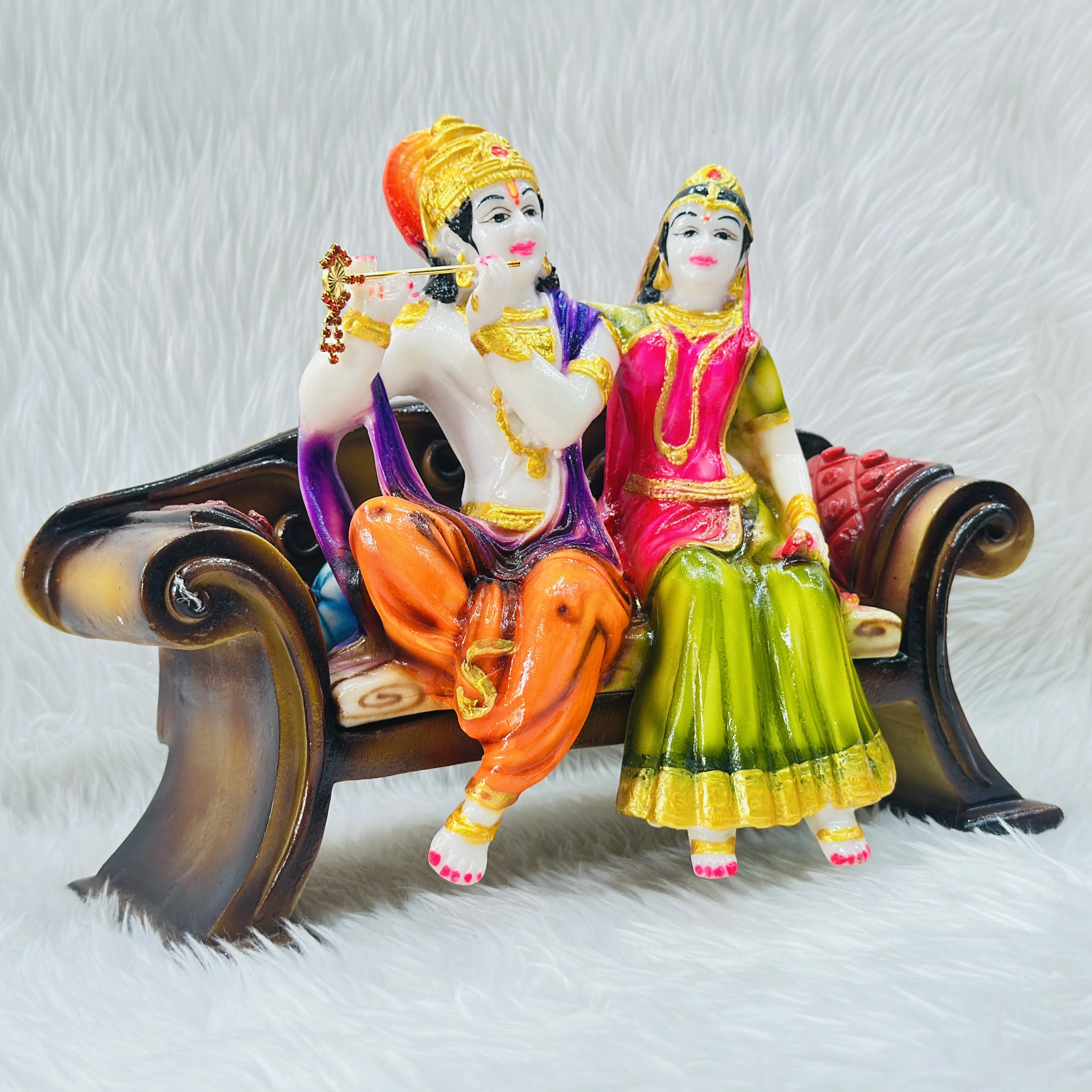 polyresin and fiberglass handicraft idol of Radha Krishna sitting on a decorative bench