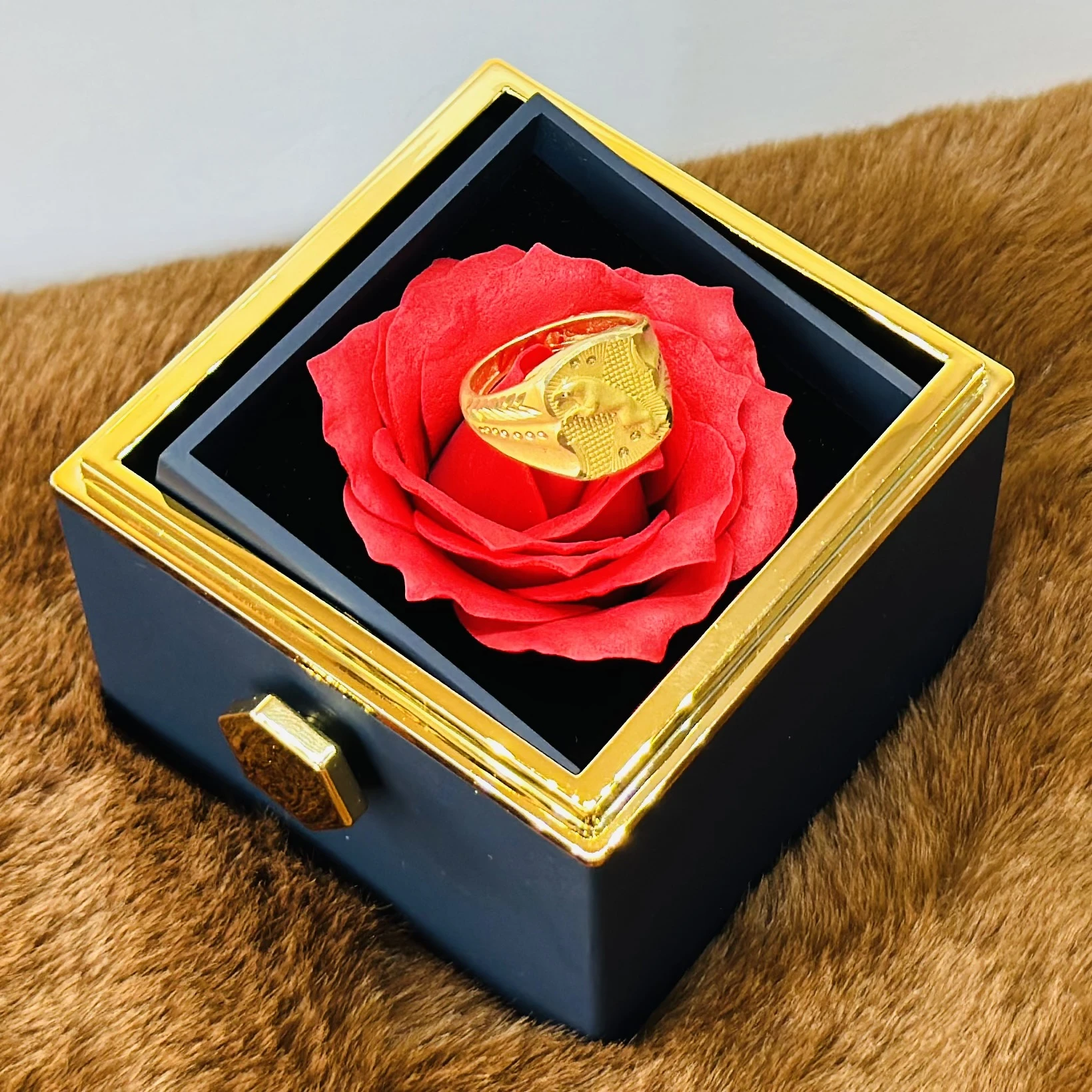 Gold toned men's ring with an embossed design